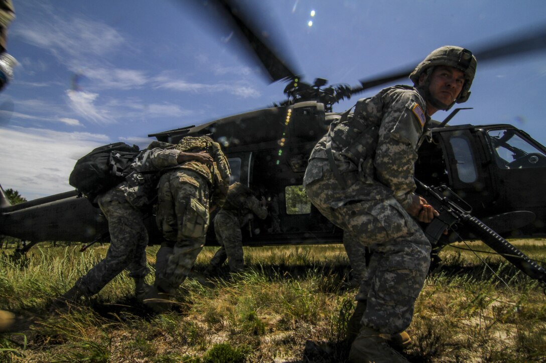 U.S. Army Reserve Soldiers from the 404th Civil Affairs Battalion transport simulated casualties to a UH-60 Black Hawk helicopter from the New Jersey Army National Guard's 1-150th Assault Helicopter Battalion during Exercise Gridiron at Joint Base McGuire-Dix-Lakehurst, N.J., June 27, 2016. (U.S. Air National Guard photo by Tech. Sgt. Matt Hecht/Released)