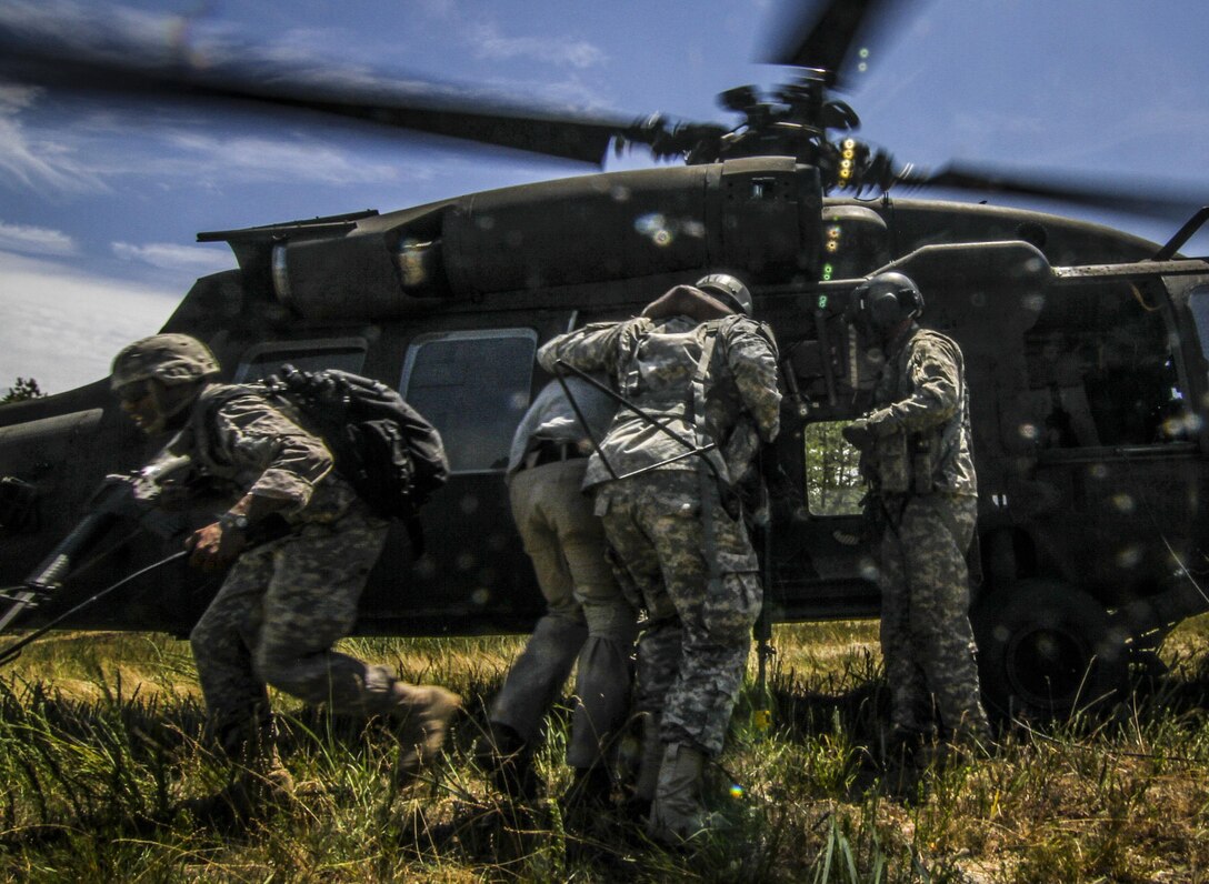 U.S. Army Reserve Soldiers from the 404th Civil Affairs Battalion transport simulated casualties to a New Jersey Army National Guard UH-60 Black Hawk helicopter during Exercise Gridiron at Joint Base McGuire-Dix-Lakehurst, N.J., June 27, 2016. (U.S. Air National Guard photo by Tech. Sgt. Matt Hecht/Released)