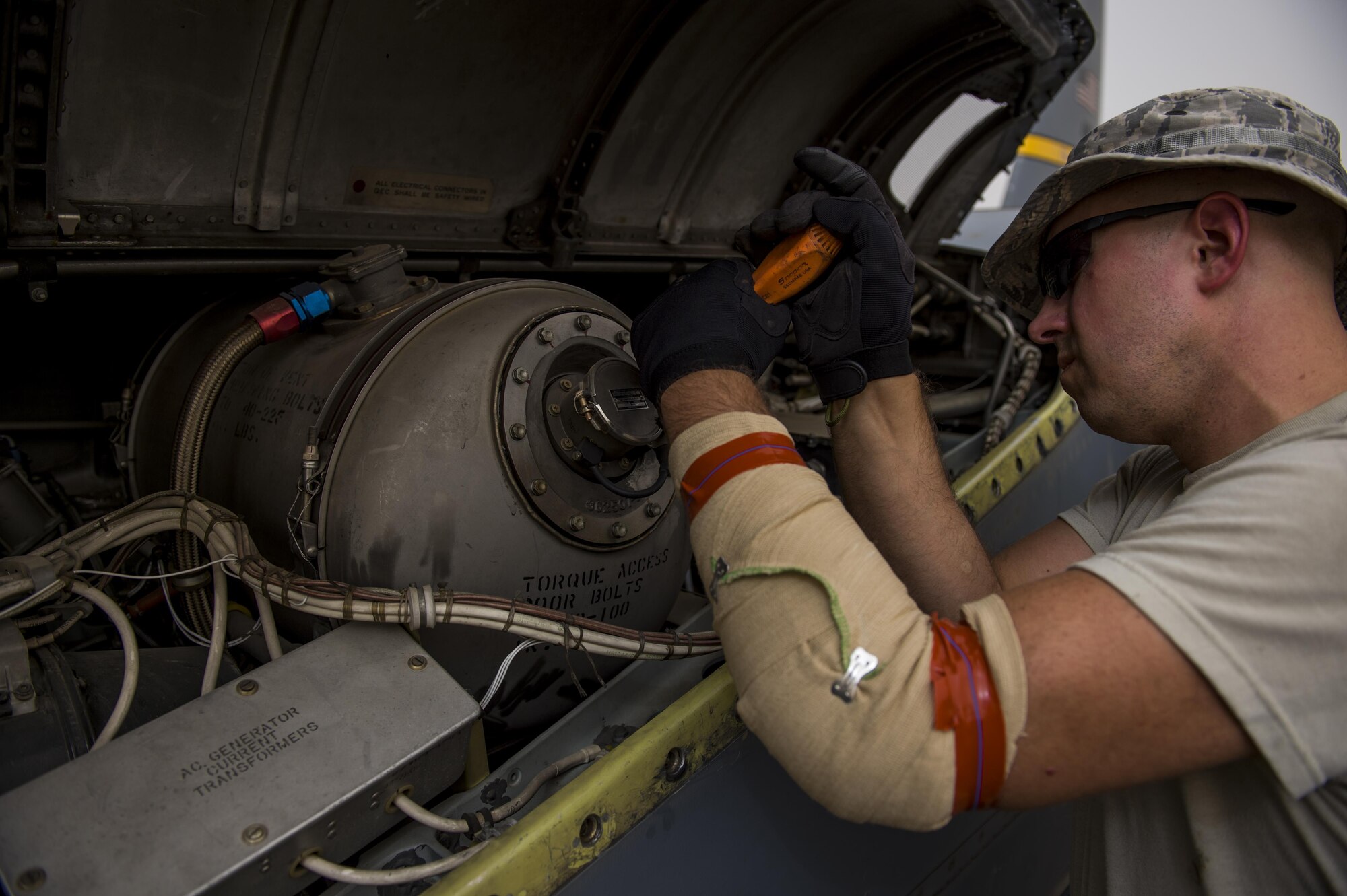 A U.S. Air Force maintainer from the Alaska Air National Guard's 144th Airlift Squadron works on a C-130 Hercules before it departs for a transport mission at an undisclosed location in Southwest Asia, June 16, 2016. The transport mission was one of the last combat missions during the 144th AS's final C-130 deployment. (U.S. Air Force photo by Staff Sgt. Douglas Ellis/Released)