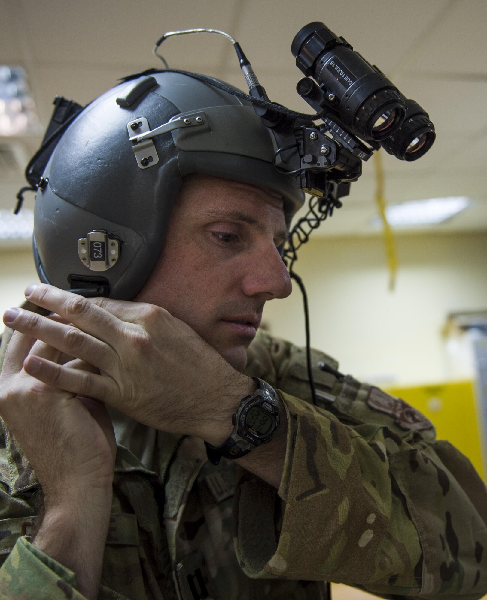 U.S. Air Force Capt. Jason Guinnee, 737th Expeditionary Airlift Squadron C-130 pilot from the Alaska Air National Guard's 144th Airlift Squadron, fastens his helmet before flying a transport mission at undisclosed location in Southwest Asia, June 17, 2016. The transport mission was one of the last combat missions during the 144th AS's final C-130 deployment. (U.S. Air Force photo by Staff Sgt. Douglas Ellis/Released)