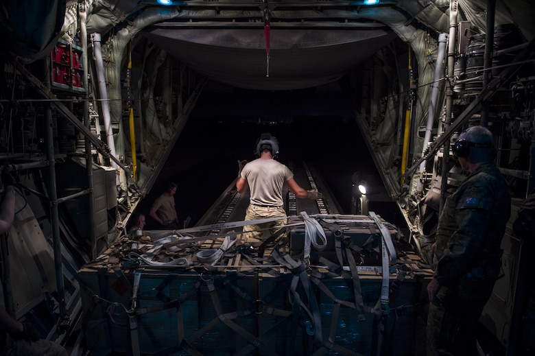A U.S. Air Force loadmaster from the Alaska Air National Guard's 144th Airlift Squadron prepares to offload cargo from a C-130 Hercules after landing in Iraq June 17, 2016. The transport mission was one of the last combat missions during the 144th AS's final C-130 deployment. (U.S. Air Force photo by Staff Sgt. Douglas Ellis/Released)