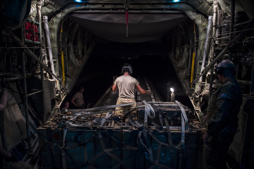 A loadmaster from the Alaska Air National Guard's 144th Airlift Squadron prepares to offload cargo from a C-130 Hercules after landing in Iraq June 17, 2016. The transport mission was one of the last combat missions during the 144th AS's final C-130 deployment. (U.S. Air Force photo/Staff Sgt. Douglas Ellis)