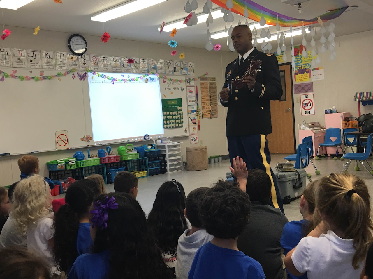 Dedicated to giving back to the community and inspiring a younger generation, Army Lt. Col. Al Niles Jr., an acquisition officer, speaks to a kindergarten class at Saint Cloud Preparatory Academy in Saint Cloud, Fla. He logged more than 250 hours of community service during his time with the Army’s Training With Industry program, supporting veterans' organizations, schools and youth programs. Courtesy photo by Tamara Carpenter