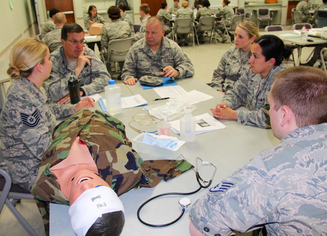 Maj. Edward Hubbelll (hand raised) makes a point about patient health care with members of the 932nd Medical Group, including the 932nd Medical Squadron and the 932nd Aeromedical Staging Squadron.  They simulated treating this patient for eye injuries and discussed real world situations at hospitals that might occur.  This type of training keeps them ready for possible deployment in the future, as the wing focuses on leading people and improving the unit going into a deployment cycle in 2017.  (U.S. Air Force photo by Maj. Stan Paregien)