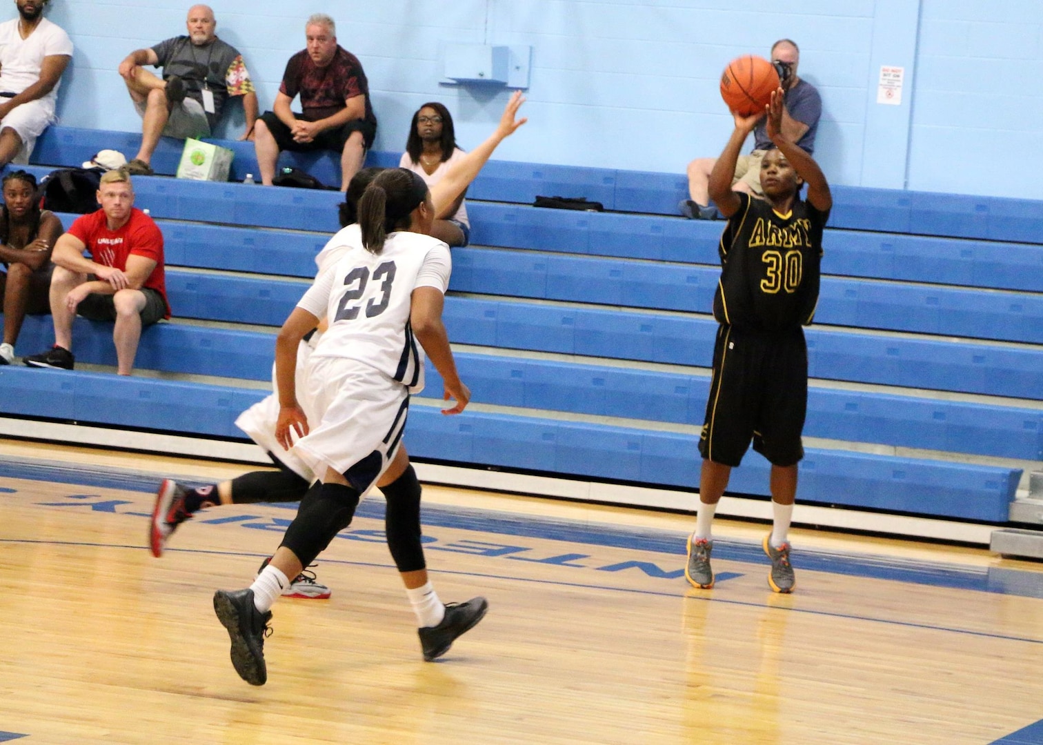 Army Spc. Donita Adams (#30) of Maryland Nat'l Guard hits a three-pointer here against Navy during game 8 of the 2016 Armed Forces Women's Basketball Championship at Joint Base San Antonio-Lackland AFB, Texas on 4 July.  Army wins the contest 90-54.