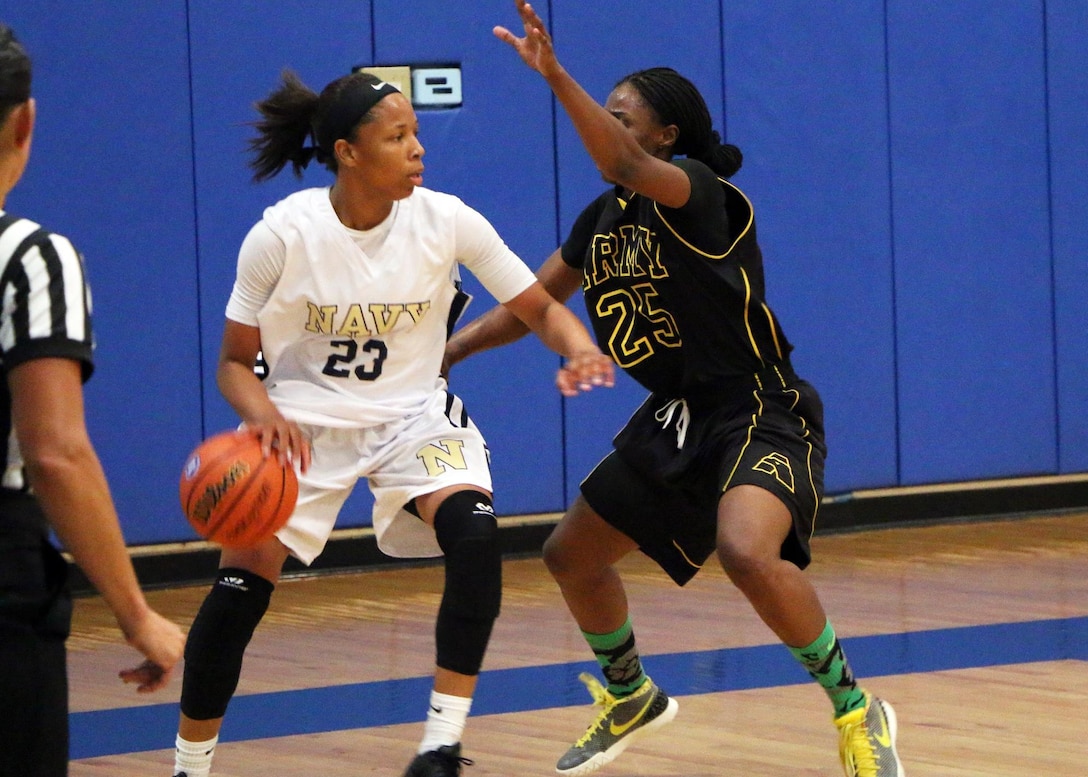 Navy Seaman Jameika Hoskins (#23) of the USS Rushmore is defended by Army Sgt. Creshenda Singletary (#25) of Fort Bragg, N.C. during game 8 of the 2016 Armed Forces Women's Basketball Championship at Joint Base San Antonio-Lackland AFB, Texas on 4 July.  Army wins the contest 90-54.