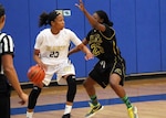 Navy Seaman Jameika Hoskins (#23) of the USS Rushmore is defended by Army Sgt. Creshenda Singletary (#25) of Fort Bragg, N.C. during game 8 of the 2016 Armed Forces Women's Basketball Championship at Joint Base San Antonio-Lackland AFB, Texas on 4 July.  Army wins the contest 90-54.