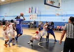 Air Force Staff Sgt. Tiffany Guthrie (#23) of JB Elmendorf–Richardson, Alaska shoots over Marine Corps in game seven of the 2016 Armed Forces Women's Basketball Championship at Joint Base San Antonio-Lackland AFB, Texas on 4 July.  Air Force wins the contest 81- 43.