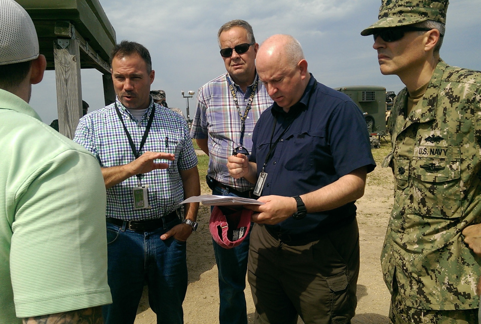Defense Logistics Agency logistics distribution team members including John Heikenin, Chuck Ensinger, Craig Hill and Navy Cmdr. Greg Eaton, discuss transportation requirements with a local logistics company during U.S. Transportation Command's Turbo Distribution 15-7 exercise at Joint Base McGuire-Dix-Lakehurst, N.J., July 22, 2015. Transcom conducts the annual exercise to assess Joint Task Force-Port Opening aerial port and distribution operations. The scenario is focused on humanitarian and disaster relief operations in a third world country. This is the first time a Defense Logistics Agency support team participated and the team deployed with the first wave of JTF-PO forces.