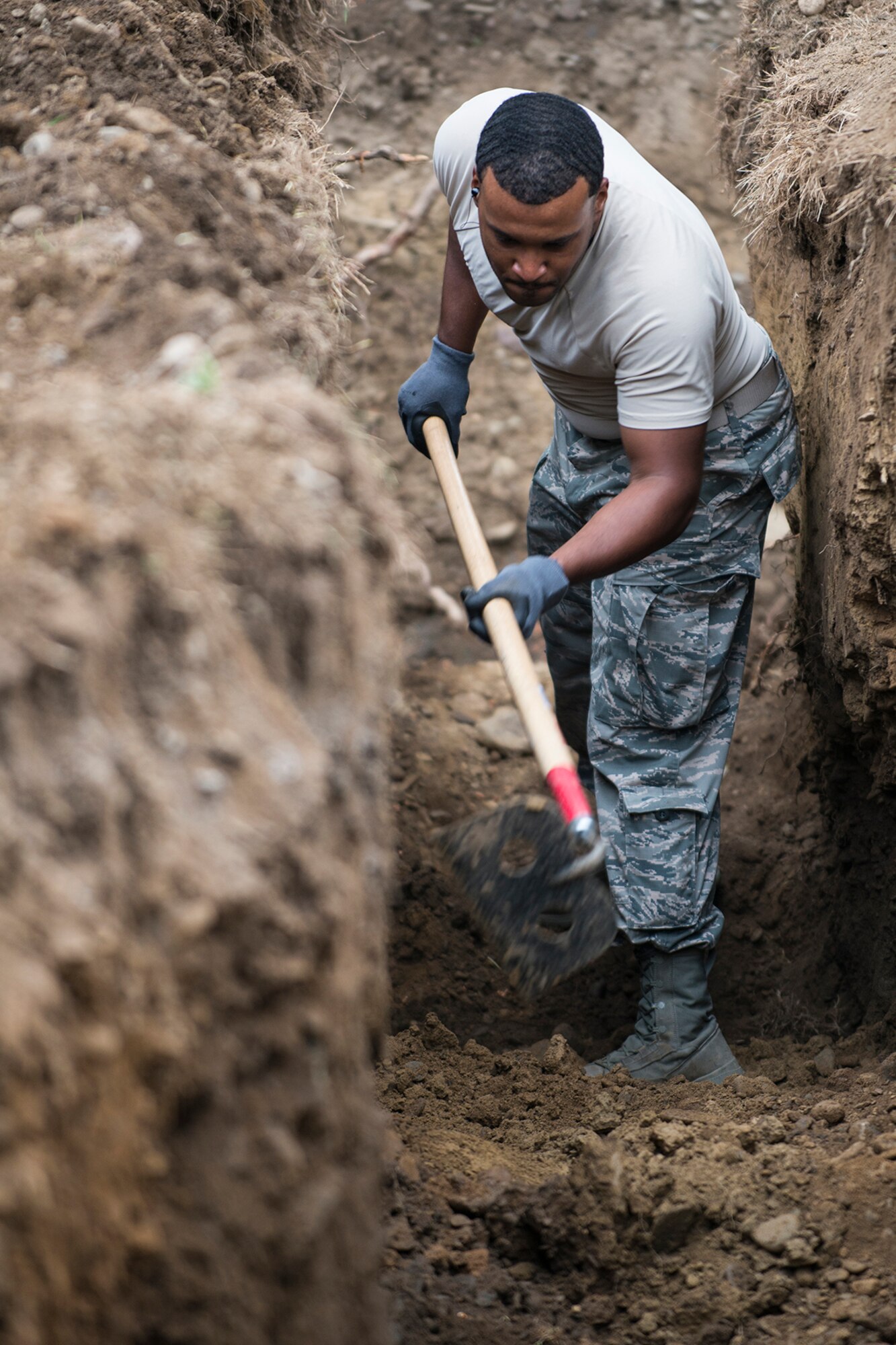 U.S. Air Force Staff Sgt. Hubert Staten, a 307th Civil Engineering Squadron (CES) heating, ventilation and air conditioning specialist, levels dirt in a trench in preparation for new water lines at the Chenango County Fairgrounds, Norwich, N.Y., June 28, 2016. The 307th CES is an Air Force Reserve squadron assigned under the 307th Bomb Wing at Barksdale Air Force Base, La., and is in Norwich to participate in a community restoration project in support of the Innovative Readiness Training Program.  (U.S. Air Force photo by Master Sgt. Greg Steele/Released)