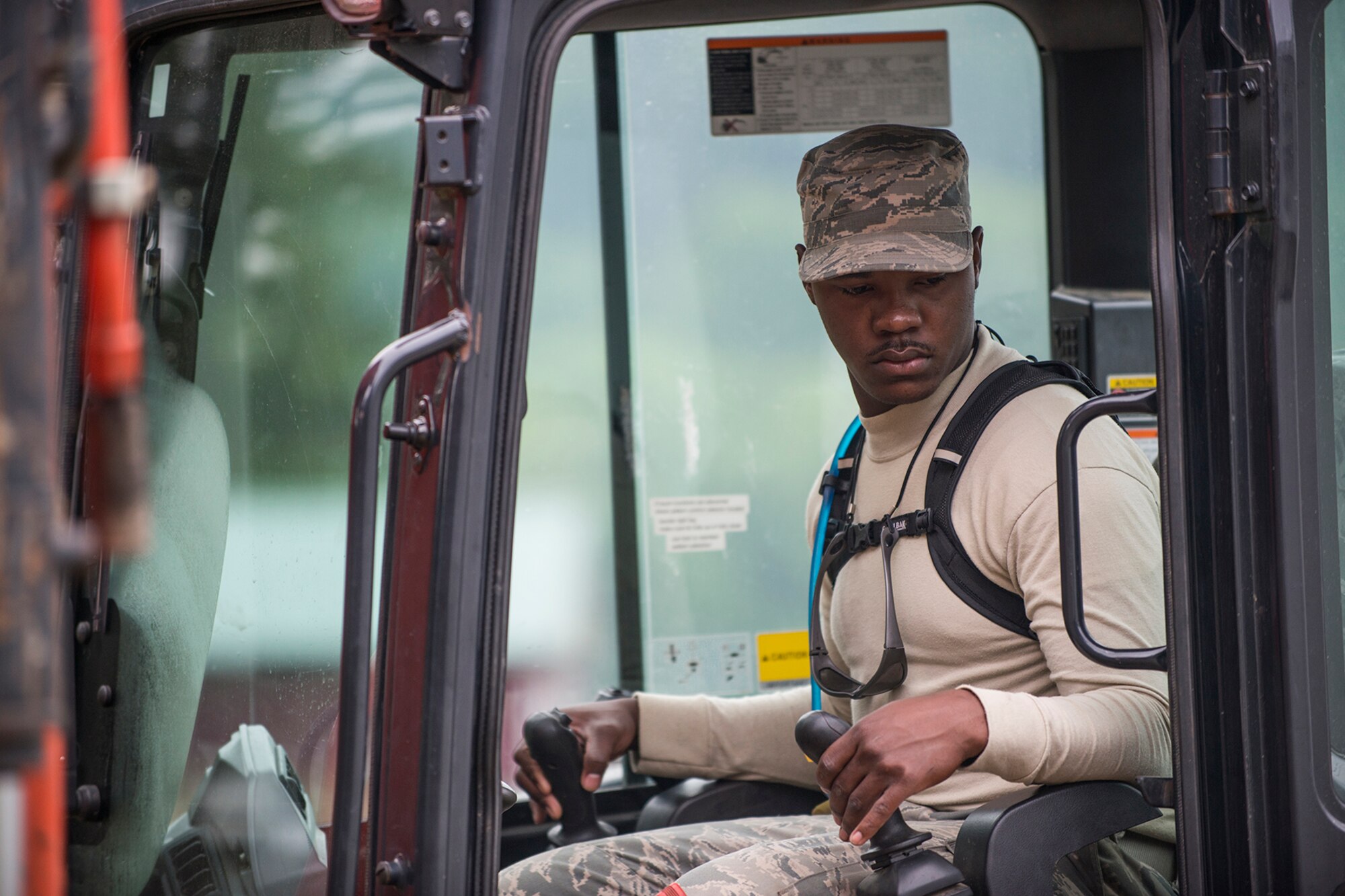 U.S. Air Force Senior Airman Derian Horton, a 307th Civil Engineering Squadron (CES) heavy equipment operator, operates a mini-excavator to dig a trench in preparation for the installation of new electrical lines at the Chenango County Fairgrounds, Norwich, N.Y., June 28, 2016. The 307th CES is an Air Force Reserve squadron assigned under the 307th Bomb Wing at Barksdale Air Force Base, La., and is in Norwich to participate in a community restoration project in support of the Innovative Readiness Training Program.  (U.S. Air Force photo by Master Sgt. Greg Steele/Released)