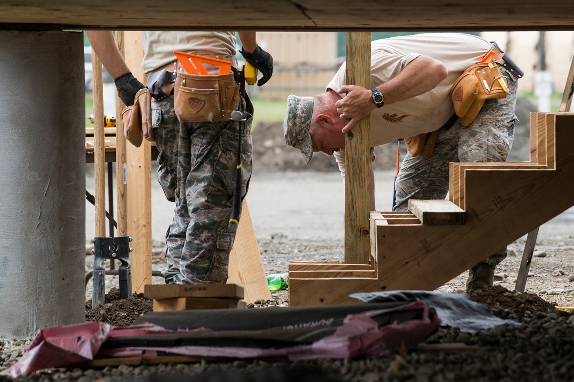 U.S. Air Force Airmen from the 307th Civil Engineering Squadron (CES) build a staircase that leads into the newly built office at the Chenango County Fairgrounds, Norwich, N.Y., June 28, 2016. The 307th CES is an Air Force Reserve squadron assigned under the 307th Bomb Wing at Barksdale Air Force Base, La., and is in Norwich to participate in a community restoration project in support of the Innovative Readiness Training Program.  (U.S. Air Force photo by Master Sgt. Greg Steele/Released)