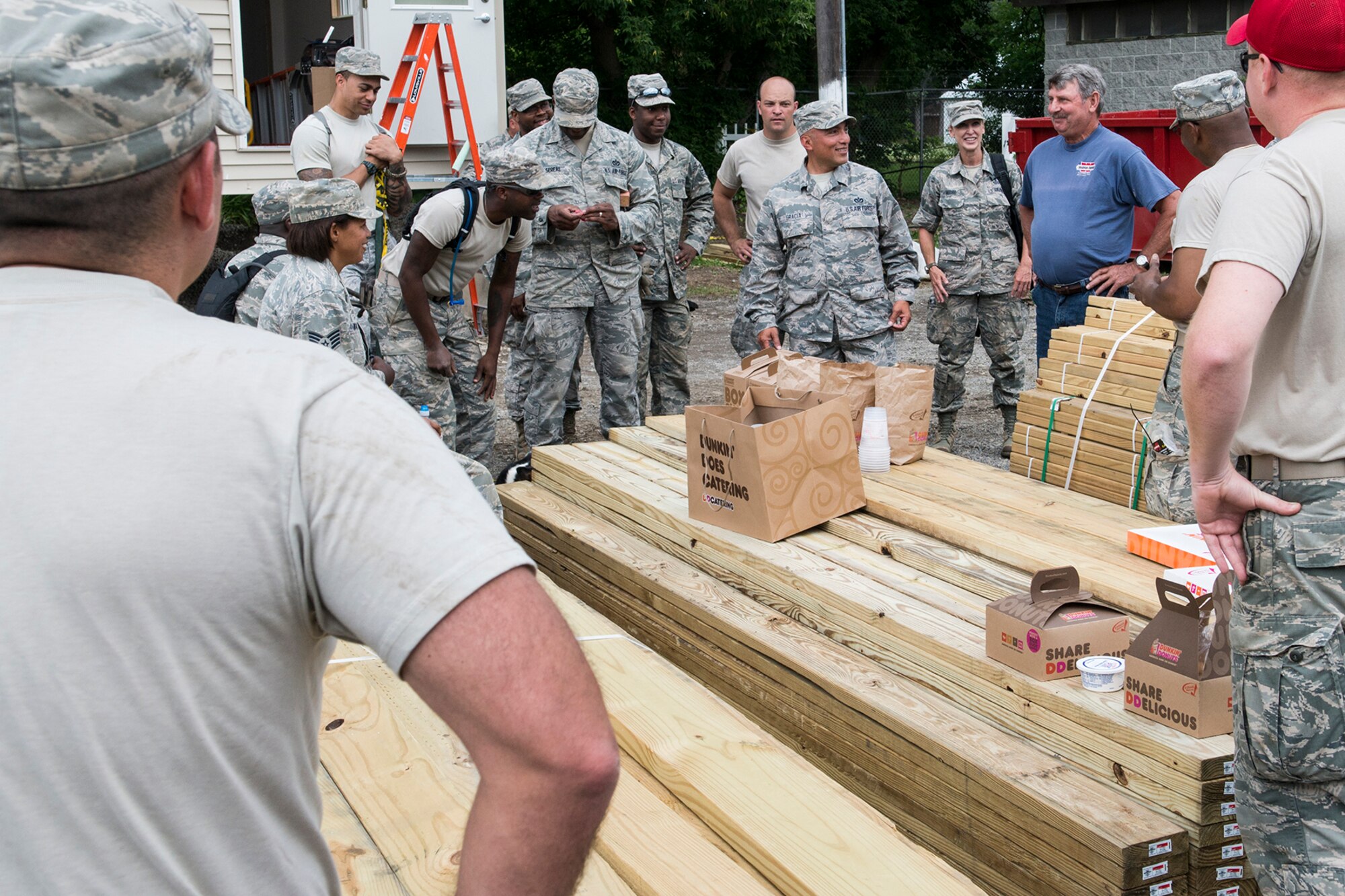 A member of the local community brings donuts and coffee to Airmen assigned to the 307th Civil Engineering Squadron at the Chenango County Fairgrounds, Norwich, N.Y., June 28, 2016. The 307th CES is an Air Force Reserve squadron assigned under the 307th Bomb Wing at Barksdale Air Force Base, La., and is in Norwich to participate in a community restoration project in support of the Innovative Readiness Training Program.  (U.S. Air Force photo by Master Sgt. Greg Steele/Released)
