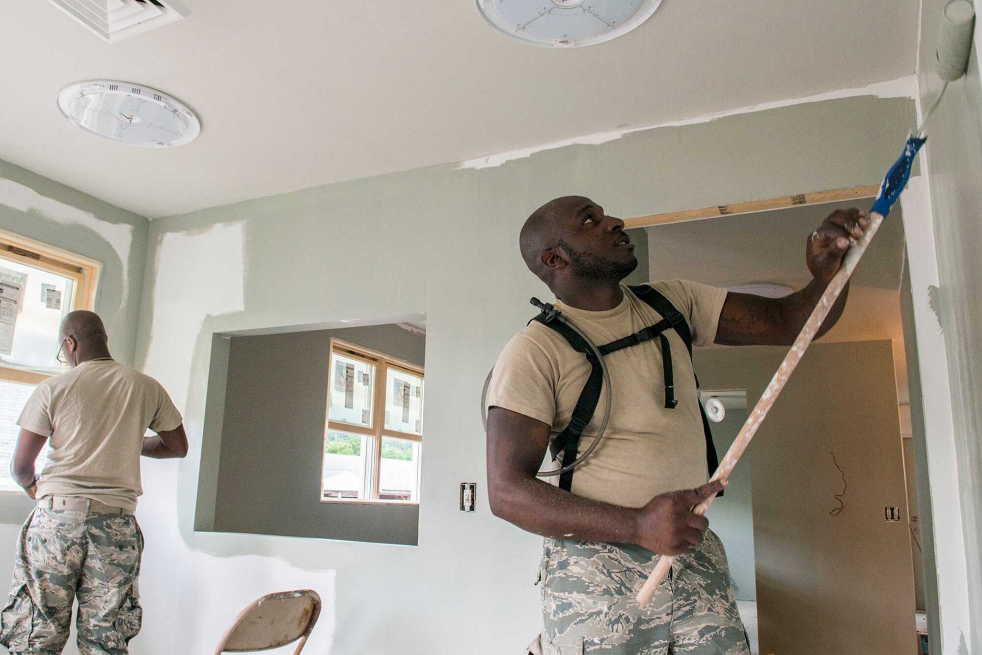 U.S. Air Force Senior Airmen Ryan Lain and Randall Neal, both assigned to the 307th Civil Engineering Squadron (CES), paint the interior walls of a new office building that was built at the Chenango County Fairgrounds, Norwich, N.Y., June 28, 2016. The 307th CES is an Air Force Reserve squadron assigned under the 307th Bomb Wing at Barksdale Air Force Base, La., and is in Norwich to participate in a community restoration project in support of the Innovative Readiness Training Program.  (U.S. Air Force photo by Master Sgt. Greg Steele/Released)