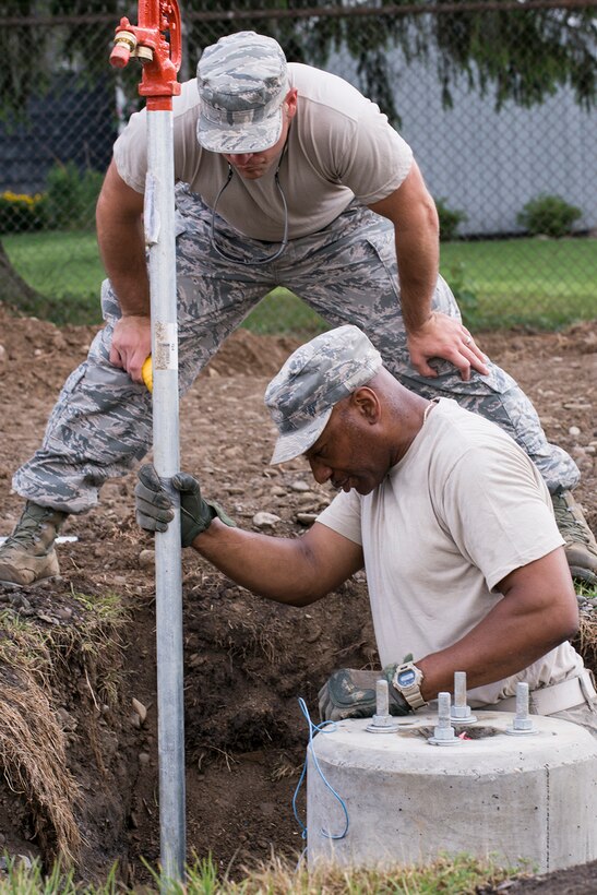 A U.S. Air Force Airman from the 307th Civil Engineering Squadron (CES) install a water faucet at the Chenango County Fairgrounds, Norwich, N.Y., June 29, 2016. The 307th CES is an Air Force Reserve squadron assigned under the 307th Bomb Wing at Barksdale Air Force Base, La., and is in Norwich to participate in a community restoration project in support of the Innovative Readiness Training Program.  (U.S. Air Force photo by Master Sgt. Greg Steele/Released)