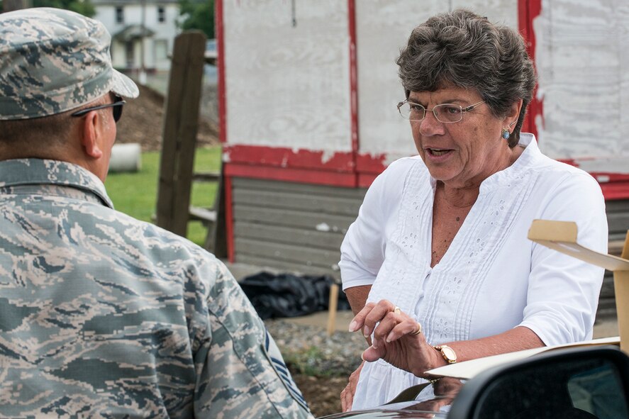 Mary Weidman, president of the Chenango County Agricultural Society (CCAS), talks with U.S. Air Force Master Sgt. Ulysses Gracia at the Chenango County Fairgrounds, Norwich, N.Y., June 29, 2016. The CCAS raised over $200,000 needed for materials and supplies for a community renovation project in support of the Innovative Readiness Training Program.  (U.S. Air Force photo by Master Sgt. Greg Steele/Released)