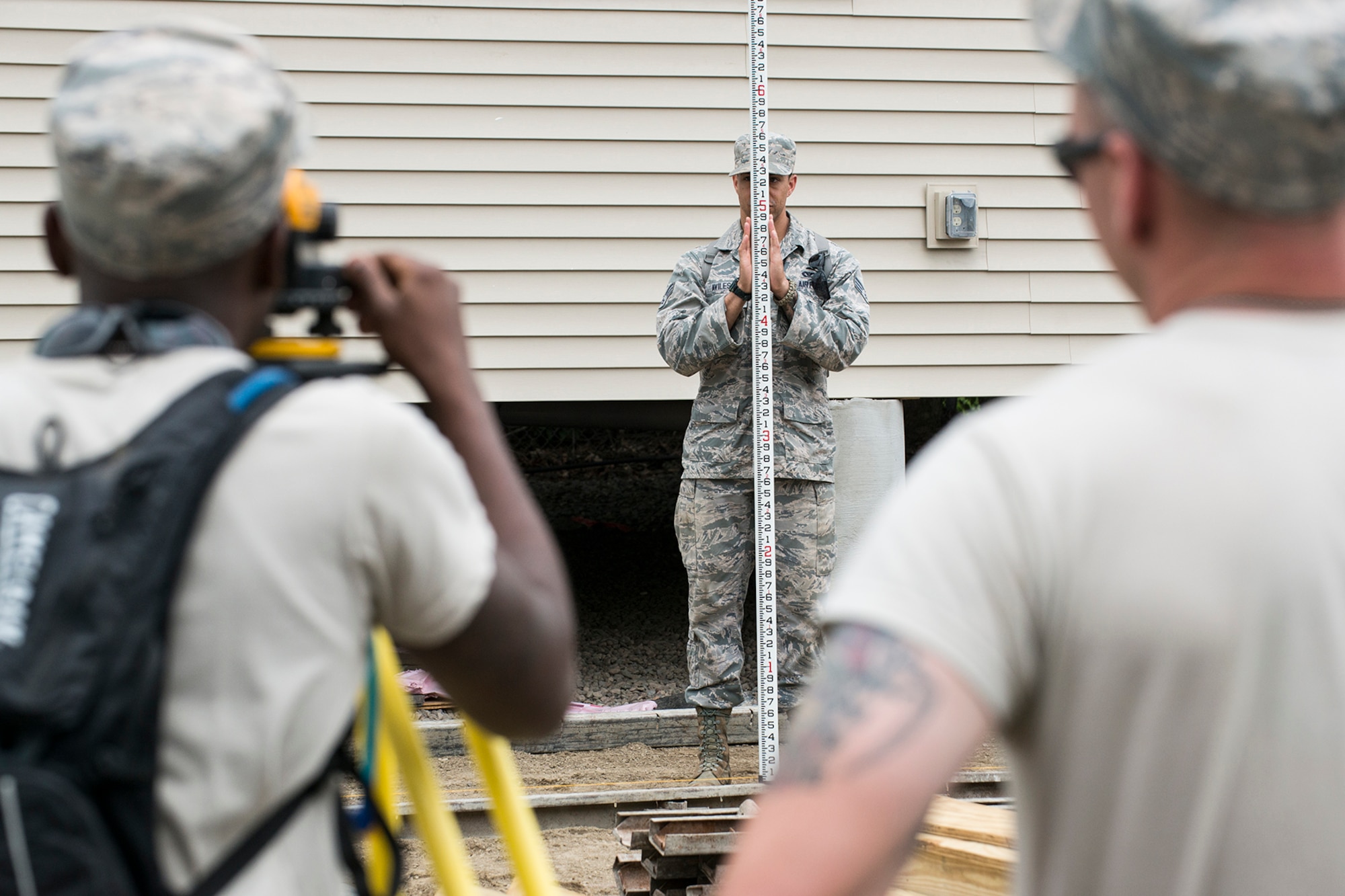 U.S. Air Force Airmen survey the ground level as they prepare to pour concrete for a sidewalk at the Chenango County Fairgrounds, Norwich, N.Y., June 29, 2016. The Airmen are from the 307th Civil Engineering Squadron at Barksdale Air Force Base, La., and are in Norwich to participate in a community restoration project in support of the Innovative Readiness Training Program. (U.S. Air Force photo by Master Sgt. Greg Steele/Released)