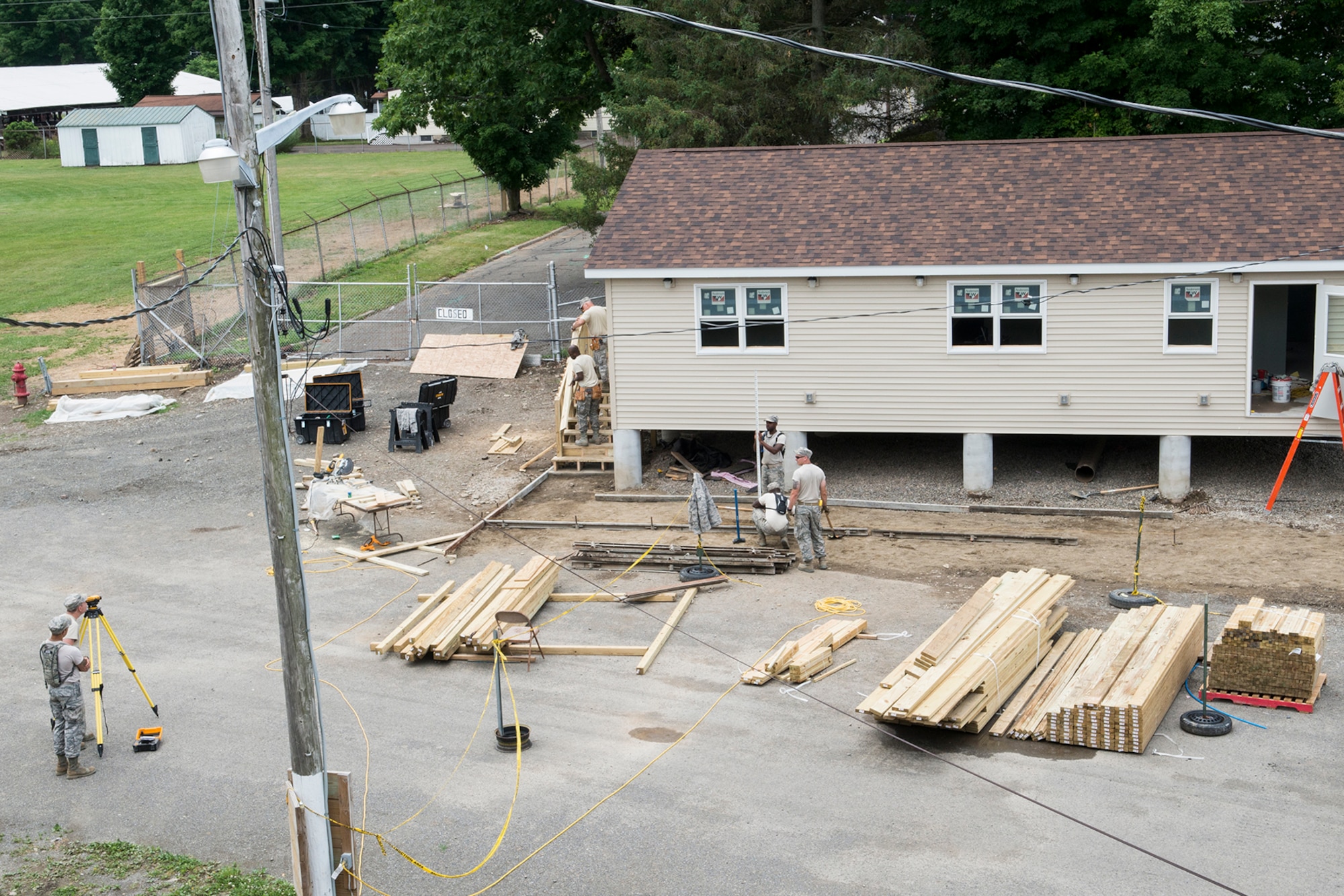 U.S. Air Force Airmen from the 307th Civil Engineering Squadron (CES) work multiple jobs on a new office building that was built at the Chenango County Fairgrounds, Norwich, N.Y., June 29, 2016. The 307th CES is an Air Force Reserve squadron assigned under the 307th Bomb Wing at Barksdale Air Force Base, La., and is in Norwich to participate in a community restoration project in support of the Innovative Readiness Training Program.  (U.S. Air Force photo by Master Sgt. Greg Steele/Released)