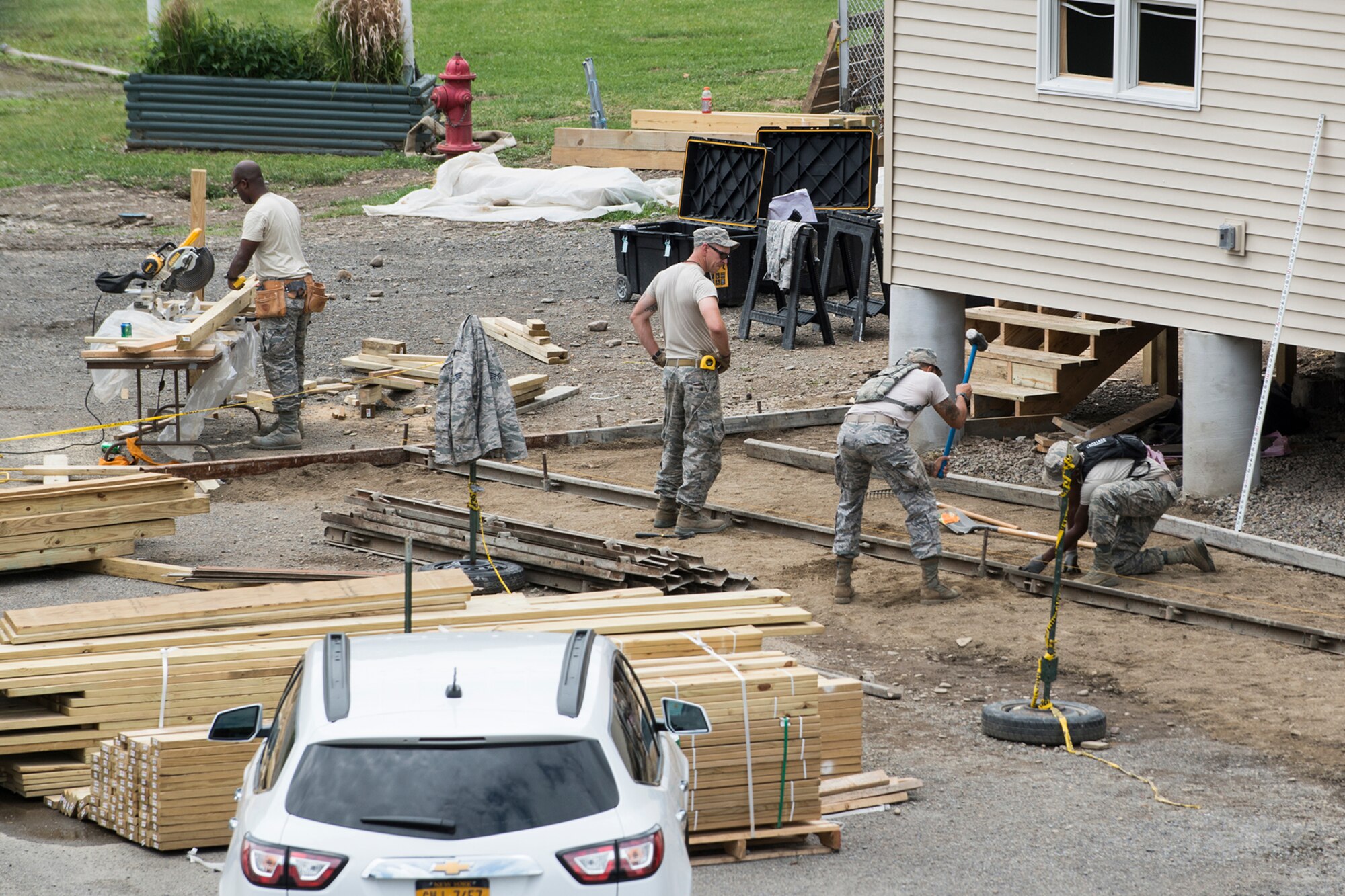 U.S. Air Force Airmen from the 307th Civil Engineering Squadron (CES) work multiple jobs on a new office building that was built at the Chenango County Fairgrounds, Norwich, N.Y., June 29, 2016. The 307th CES is an Air Force Reserve squadron assigned under the 307th Bomb Wing at Barksdale Air Force Base, La., and is in Norwich to participate in a community restoration project in support of the Innovative Readiness Training Program.  (U.S. Air Force photo by Master Sgt. Greg Steele/Released)