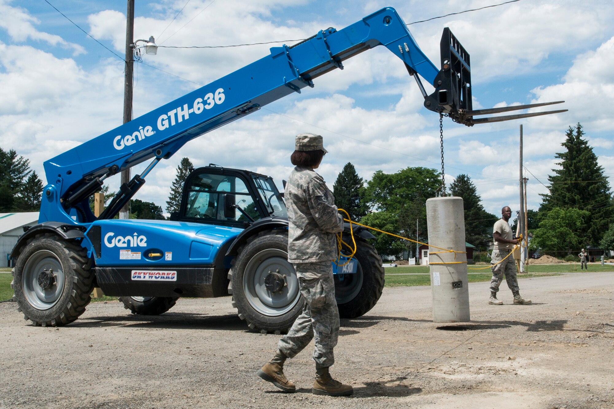 U.S. Air Force Airmen from the 307th Civil Engineering Squadron (CES) carefully guide a 1,400 pound concrete pillar to its final resting place at the Chenango County Fairgrounds, Norwich, N.Y., June 30, 2016. The 307th CES is an Air Force Reserve squadron assigned under the 307th Bomb Wing at Barksdale Air Force Base, La., and is in Norwich to participate in a community restoration project in support of the Innovative Readiness Training Program.  (U.S. Air Force photo by Master Sgt. Greg Steele/Released)