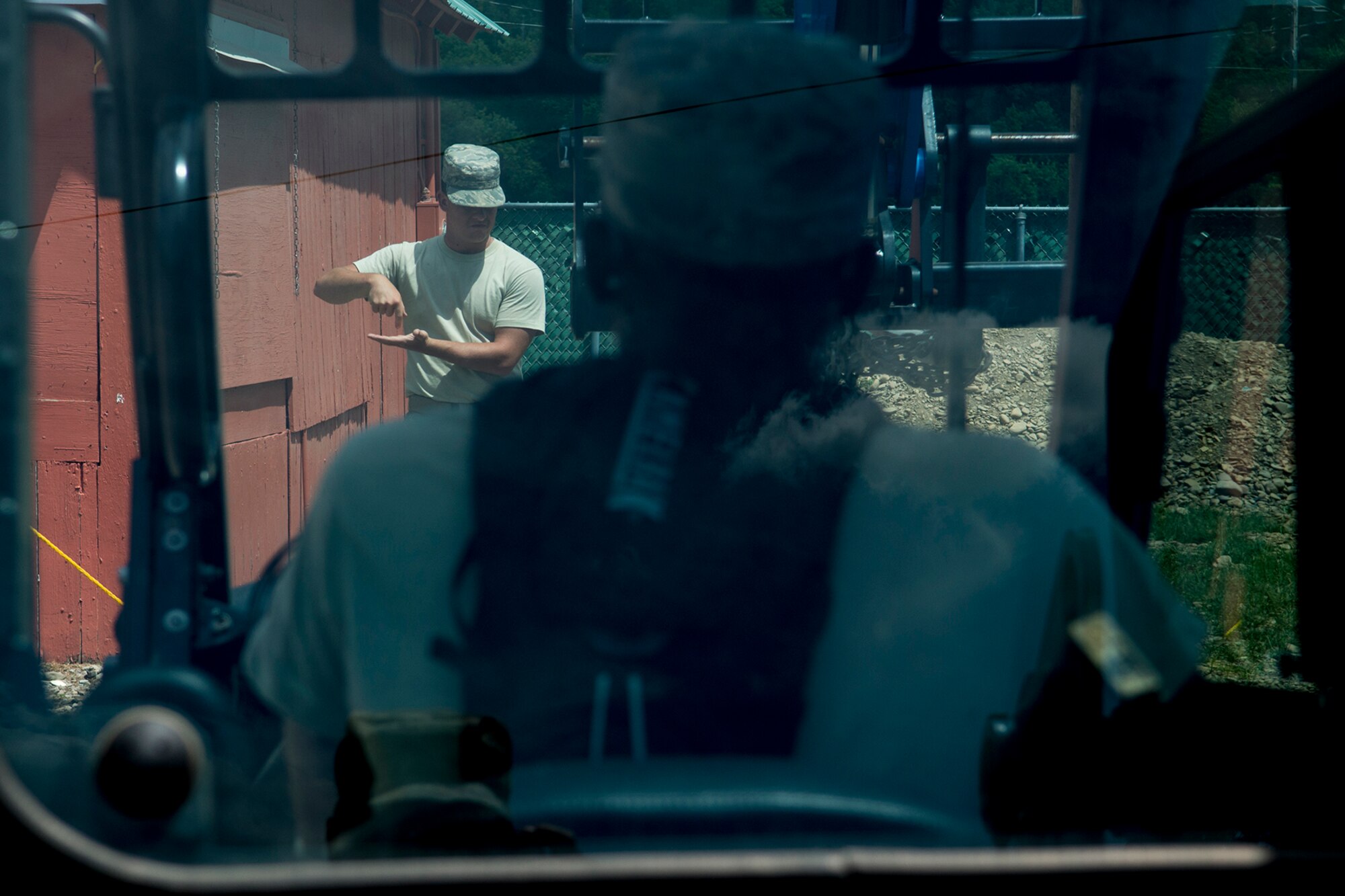 A U.S. Air Force Airman directs the drive of a heavy forklift to lower the boom during a project at the Chenango County Fairgrounds, Norwich, N.Y., June 30, 2016. The Airmen are from the 307th Civil Engineers Squadron, which is an Air Force Reserve squadron assigned under the 307th Bomb Wing at Barksdale Air Force Base, La., and is in Norwich to participate in a community restoration project in support of the Innovative Readiness Training Program.  (U.S. Air Force photo by Master Sgt. Greg Steele/Released)