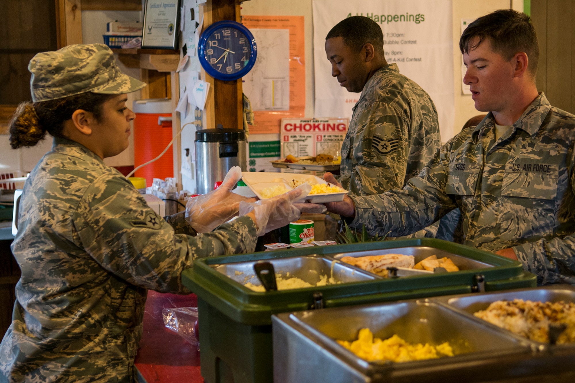 U.S. Air Force Airmen from the 307th Civil Engineering Squadron (CES) are served breakfast from a kitchen set up on the Chenango County Fairgrounds, Norwich, N.Y., July 1, 2016. The 307th CES is an Air Force Reserve squadron assigned under the 307th Bomb Wing at Barksdale Air Force Base, La., and lived under deployment conditions while participating in a renovation project as part of the Innovative Readiness Training Program.  (U.S. Air Force photo by Master Sgt. Greg Steele/Released)
