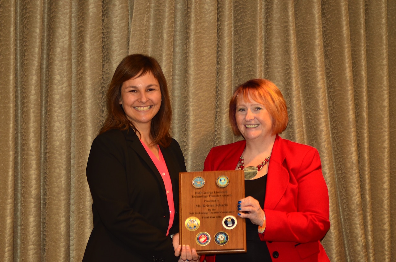 Kristen Schario, right, receives the 2016 George Linsteadt Technology Transfer Achievement Award from Deputy Assistant Secretary of Defense for Research Dr. Melissa L. Flagg, during a ceremony in Chicago, June 29, 2016. Courtesy photo