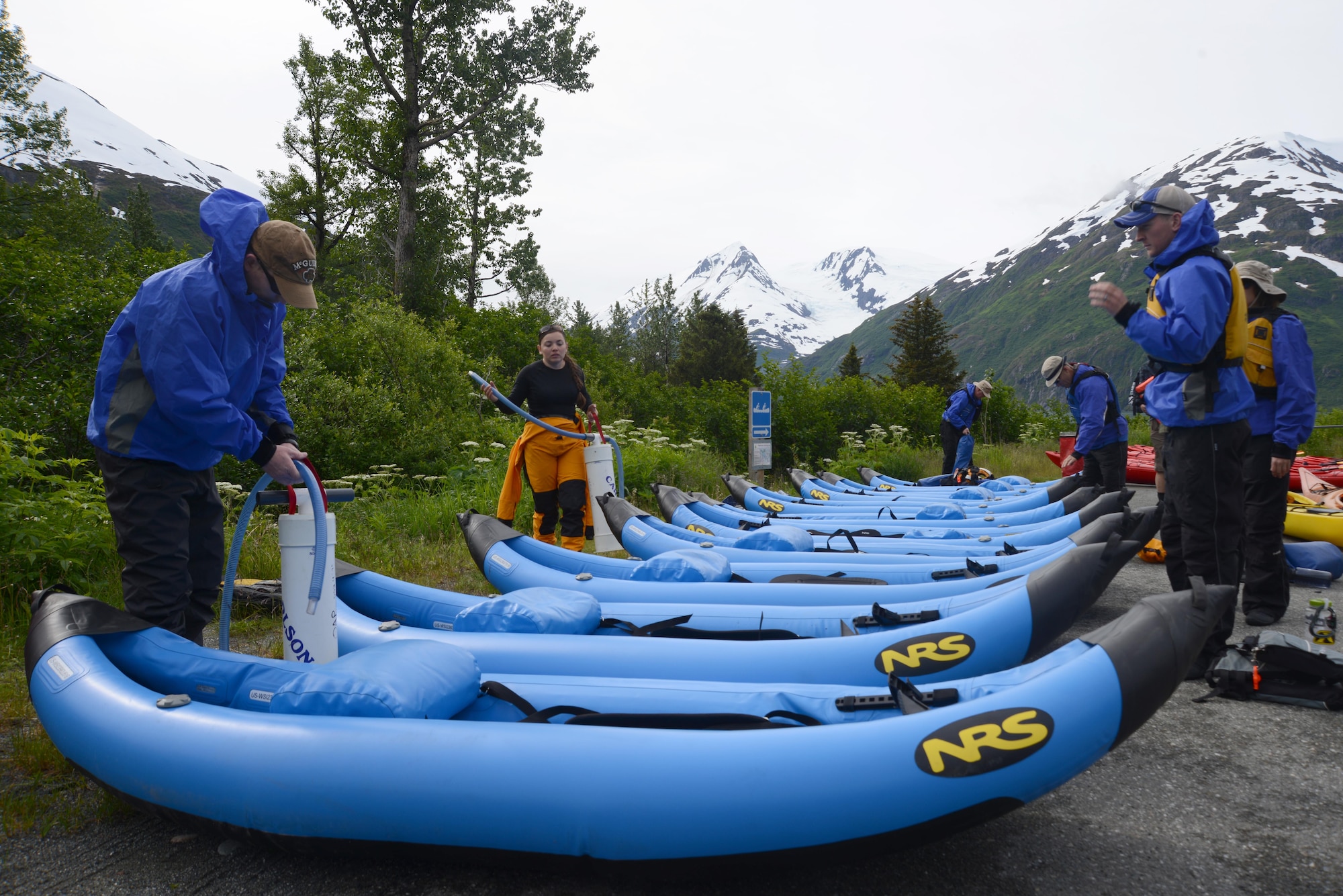 Participants of the first Outdoor Recreation Program inflatable kayaking trip prepare to pump the kayaks outside Portage Lake, Alaska, June 12, 2016. Inflatable kayaks, unlike other kayaks, are filled with air and weigh much less. The OAP has introduced inflatable kayaking as the newest addition to the multiple trips available in the summer. (U.S. Air Force photo by Airman 1st Class Christopher R. Morales)