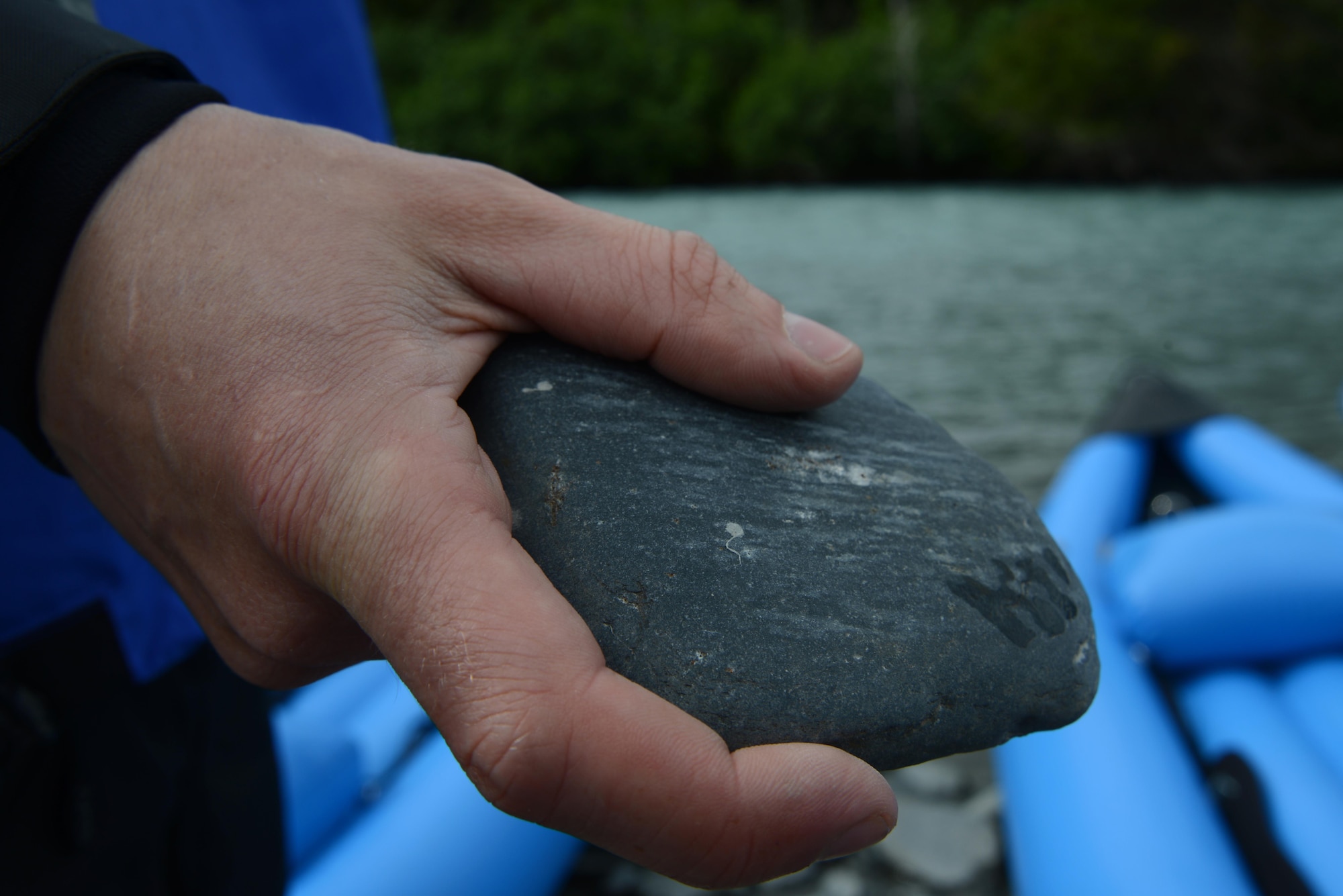 A kayaker skips stones at Portage River, Alaska, June 12, 2016. The kayaking trip took a few pauses along the way to rest, stretch, enjoy the view, and skip stones. Portage Lake was created by the glacial water of Portage Glacier and flows to Turnagain Arm. The OAP has introduced inflatable kayaking as the newest addition to the multiple trips available in the summer. (U.S. Air Force photo by Airman 1st Class Christopher R. Morales)