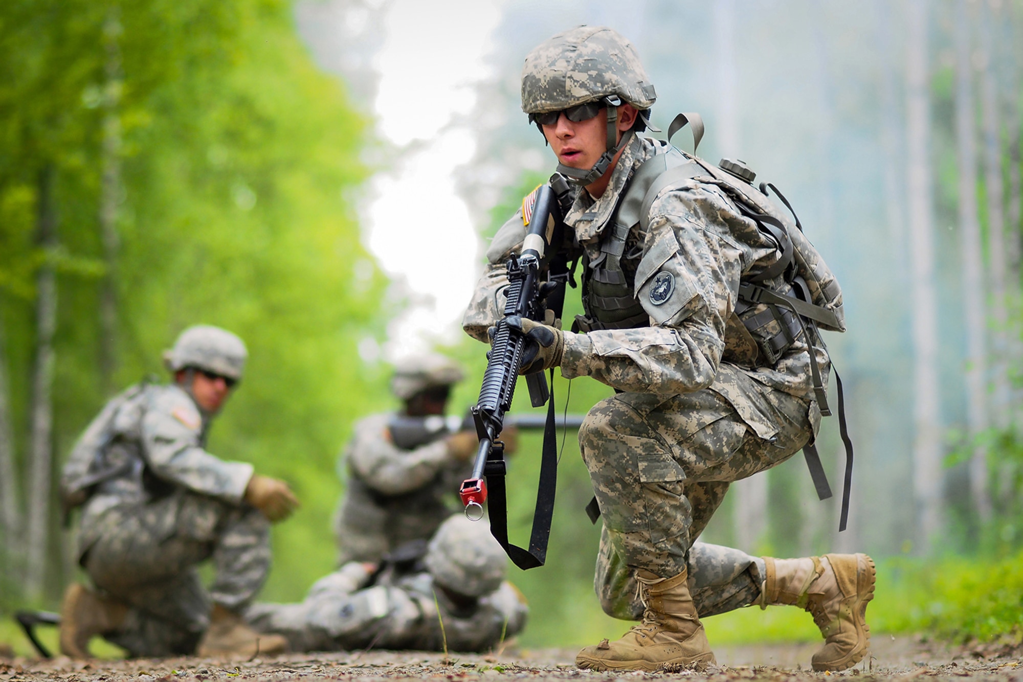 Army Pfc. Richard Burger, a native of Independence, Mo., assigned to the 574th Quartermaster Company, 17th Combat Sustainment Support Battalion, U.S. Army Alaska, pulls security as fellow Soldiers provide medical attention to a simulated casualty on a Situation Exercise Training lane during the Ready Warrior Competition at Camp Madbull on Joint Base Elmendorf-Richardson, Alaska, Thursday, June 23, 2016.  The three-day competition tested teams of Soldiers in physical fitness, small arms proficiency, land navigation, and small-unit tactics as well as other Soldier skills. (U.S. Air Force photo/Justin Connaher)