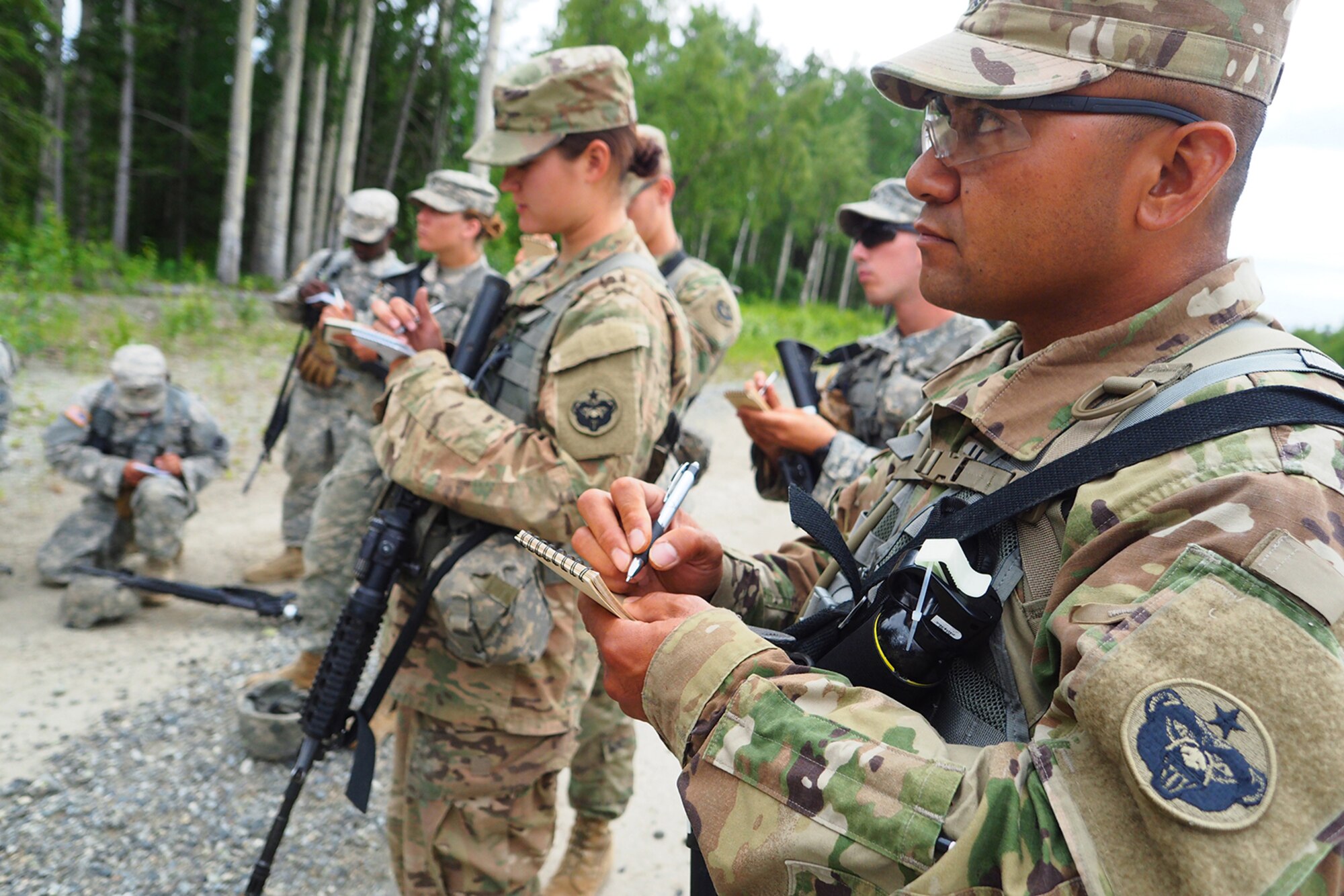 Army Sgt. Norbert Iriarte, a native of Mangilao, Guam, assigned to the 17th Combat Sustainment Support Battalion, U.S. Army Alaska, takes notes during a safety briefing before a Situation Exercise Training lane during the Ready Warrior Competition at Camp Madbull on Joint Base Elmendorf-Richardson, Alaska, Thursday, June 23, 2016.  The three-day competition tested teams of Soldiers in physical fitness, small arms proficiency, land navigation, and small-unit tactics as well as other Soldier skills. (U.S. Air Force photo/Justin Connaher)