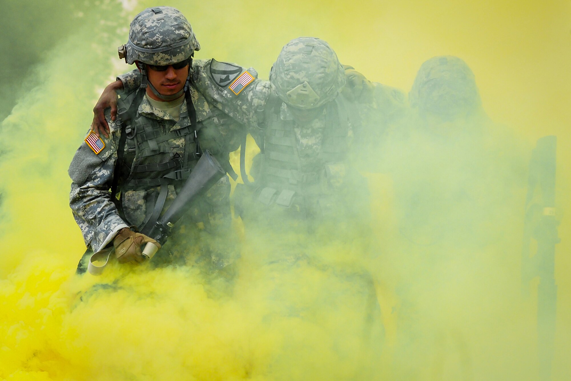 Army Pfc. Tim Hofmann, a native of Atwater, Minn., left, and Spc. Alex Sidoa, a native of Houston, Texas, help Army Sgt. Michael Barnes, a native of Minneapolis, Minn., through the smoke marking a simulated casualty extraction point during a Situation Exercise Training lane during the Ready Warrior Competition at Camp Madbull on Joint Base Elmendorf-Richardson, Alaska, Thursday, June 23, 2016.  The three-day competition tested teams of Soldiers assigned to U.S. Army Alaska’s 17th Combat Sustainment Support Battalion in physical fitness, small arms proficiency, land navigation, and small-unit tactics as well as other Soldier skills. (U.S. Air Force photo/Justin Connaher)