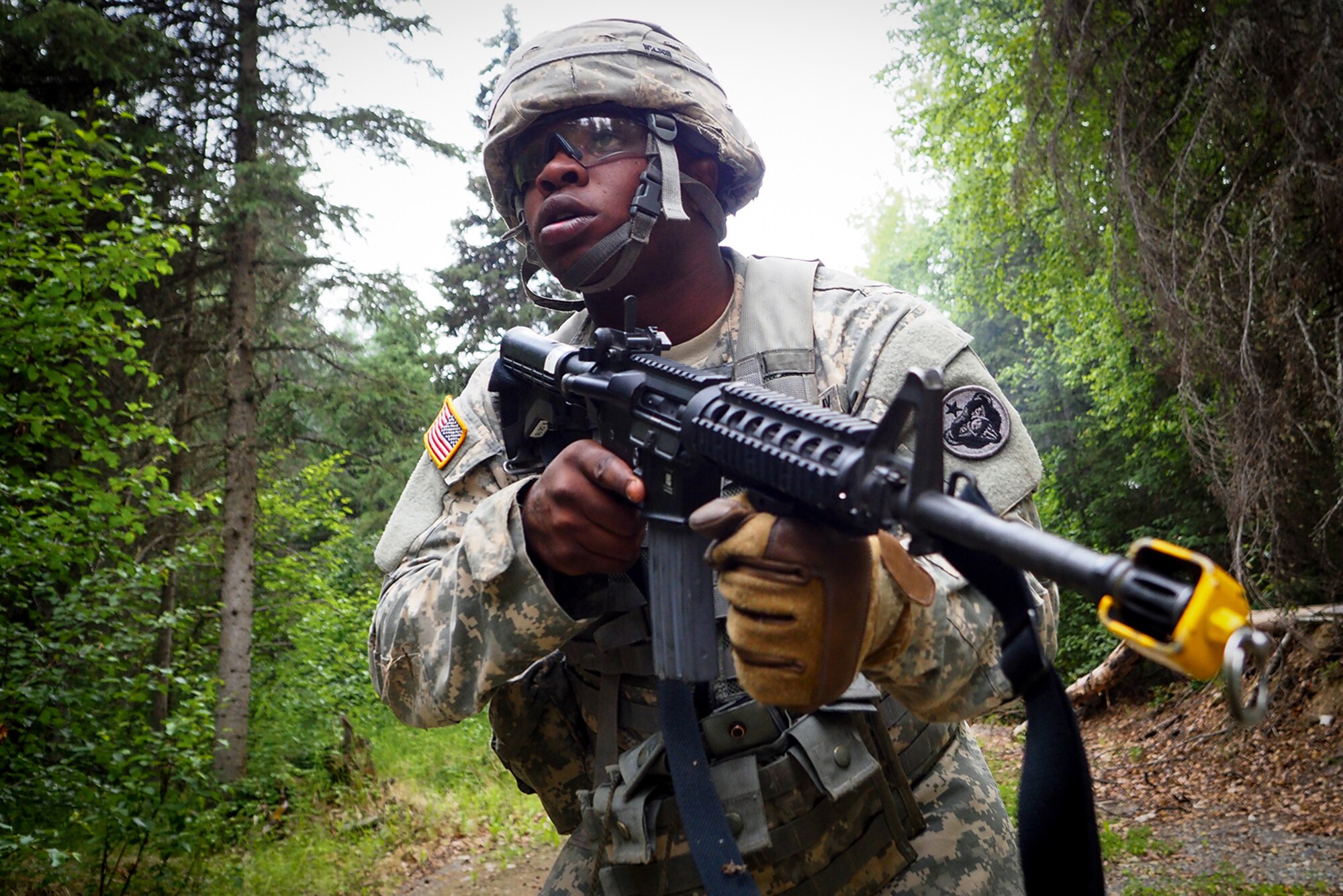 Spc. Gerald Wilson, a native of Dallas, Texas, assigned to the 486th Movement Control Team, 17th Combat Sustainment Support Battalion, U.S. Army Alaska, leads his team on a Situation Exercise Training lane during the Ready Warrior Competition at Camp Madbull on Joint Base Elmendorf-Richardson, Alaska, Thursday, June 23, 2016.  The three-day competition tested teams of Soldiers in physical fitness, small arms proficiency, land navigation, and small-unit tactics as well as other Soldier skills. (U.S. Air Force photo/Justin Connaher)