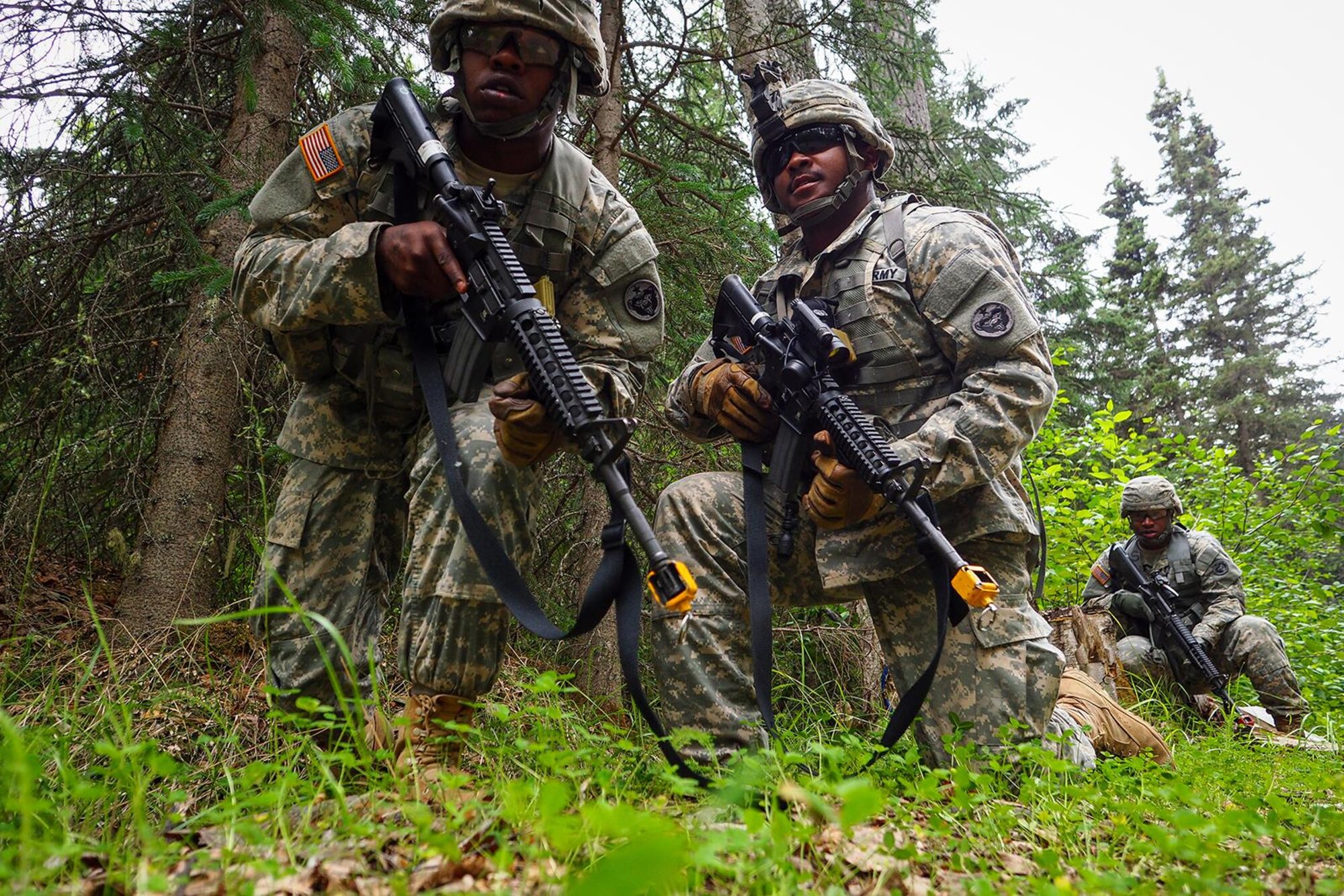 Spc. Gerald Wilson, a native of Dallas, Texas, left, Army Sgt. Melvin Holloman, a native of Jonesboro, Ga., and Army Pfc. Ichwandt Savage, a native of Philadelphia, Pa., all assigned to the 486th Movement Control Team, 17th Combat Sustainment Support Battalion, U.S. Army Alaska, work as a team through a Situation Exercise Training lane during the Ready Warrior Competition at Camp Madbull on Joint Base Elmendorf-Richardson, Alaska, Thursday, June 23, 2016.  The three-day competition tested teams of Soldiers in physical fitness, small arms proficiency, land navigation, and small-unit tactics as well as other Soldier skills. (U.S. Air Force photo/Justin Connaher)