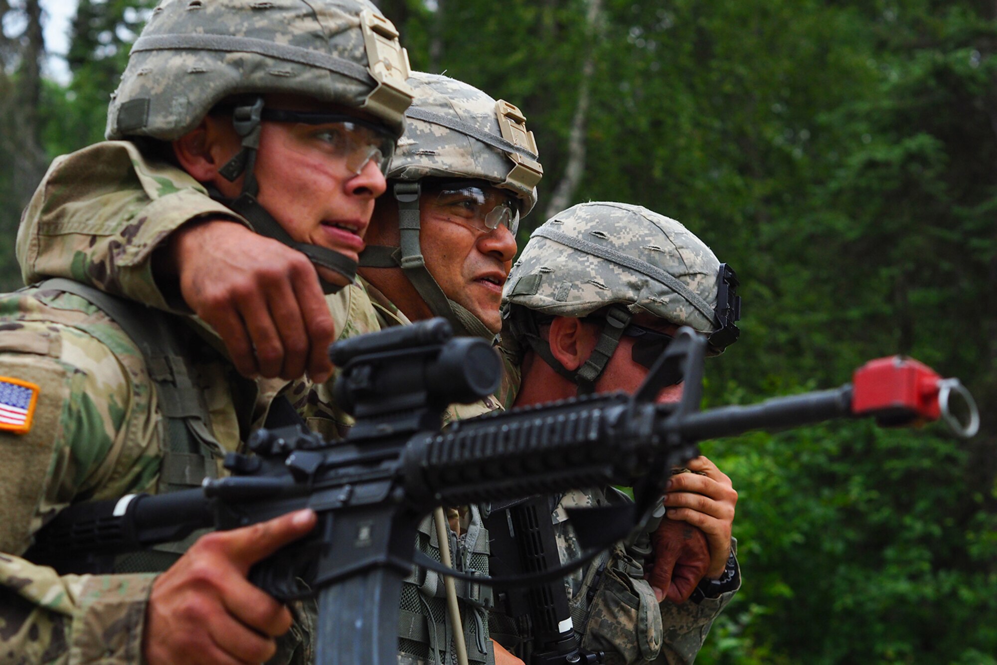 Army Pfc Tyler Read, Houston, Texas, left, Army Sgt. Norbert Iriarte, a native of Mangilao, Guam, and Army Pfc. Joseph Feola, a native of Springhill, Fla., all assigned to the 17th Combat Sustainment Support Battalion, U.S. Army Alaska, work as a team through a Situation Exercise Training lane during the Ready Warrior Competition at Camp Madbull on Joint Base Elmendorf-Richardson, Alaska, Thursday, June 23, 2016.  The three-day competition tested teams of Soldiers in physical fitness, small arms proficiency, land navigation, and small-unit tactics as well as other Soldier skills. (U.S. Air Force photo/Justin Connaher)