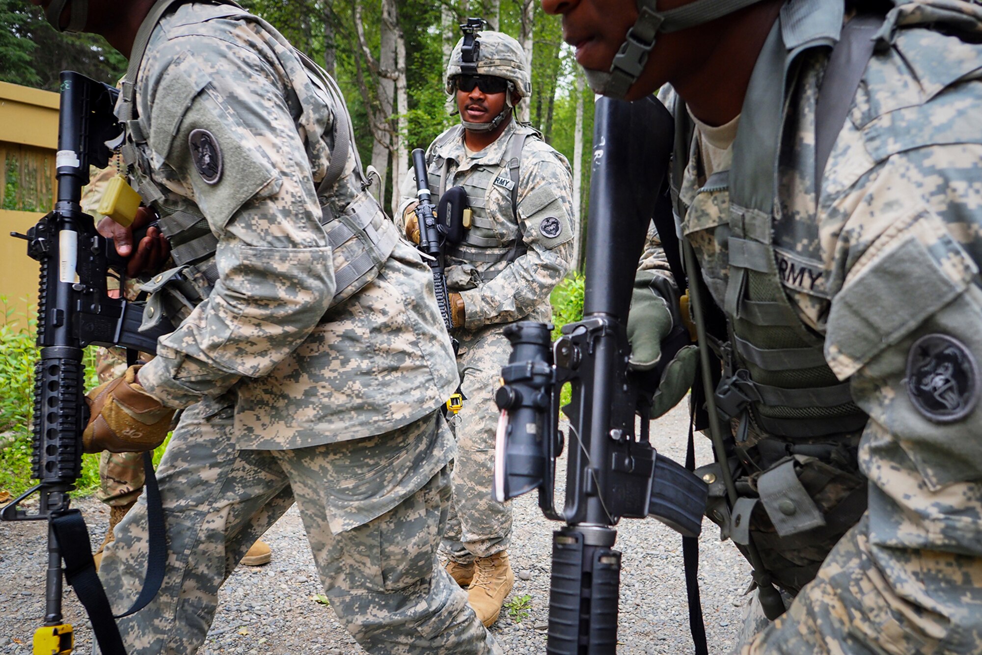 Army Sgt. Melvin Holloman, a native of Jonesboro, Ga., assigned to the 486th Movement Control Team, 17th Combat Sustainment Support Battalion, U.S. Army Alaska, is seen between fellow Soldiers after giving them orders to continue a patrol on a Situation Exercise Training lane during the Ready Warrior Competition at Camp Madbull on Joint Base Elmendorf-Richardson, Alaska, Thursday, June 23, 2016.  The three-day competition tested teams of Soldiers in physical fitness, small arms proficiency, land navigation, and small-unit tactics as well as other Soldier skills. (U.S. Air Force photo/Justin Connaher)