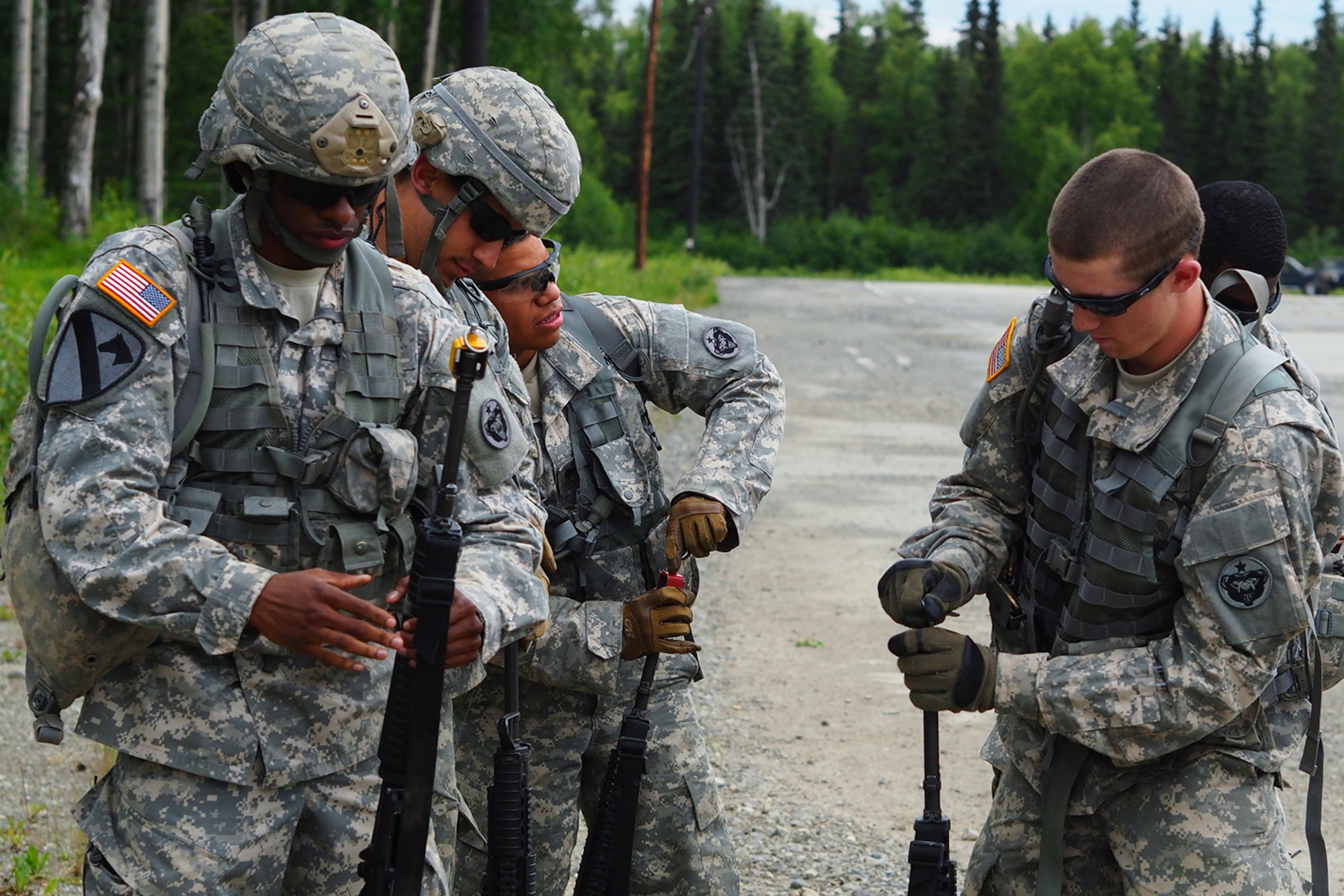 Soldiers assigned to the 17th Combat Sustainment Support Battalion, U.S. Army Alaska, fit Blank Firing Adapters to their weapons before a Situation Exercise Training lane during the Ready Warrior Competition at Camp Madbull on Joint Base Elmendorf-Richardson, Alaska, Thursday, June 23, 2016.  The three-day competition tested teams of Soldiers in physical fitness, small arms proficiency, land navigation, and small-unit tactics as well as other Soldier skills. (U.S. Air Force photo/Justin Connaher)