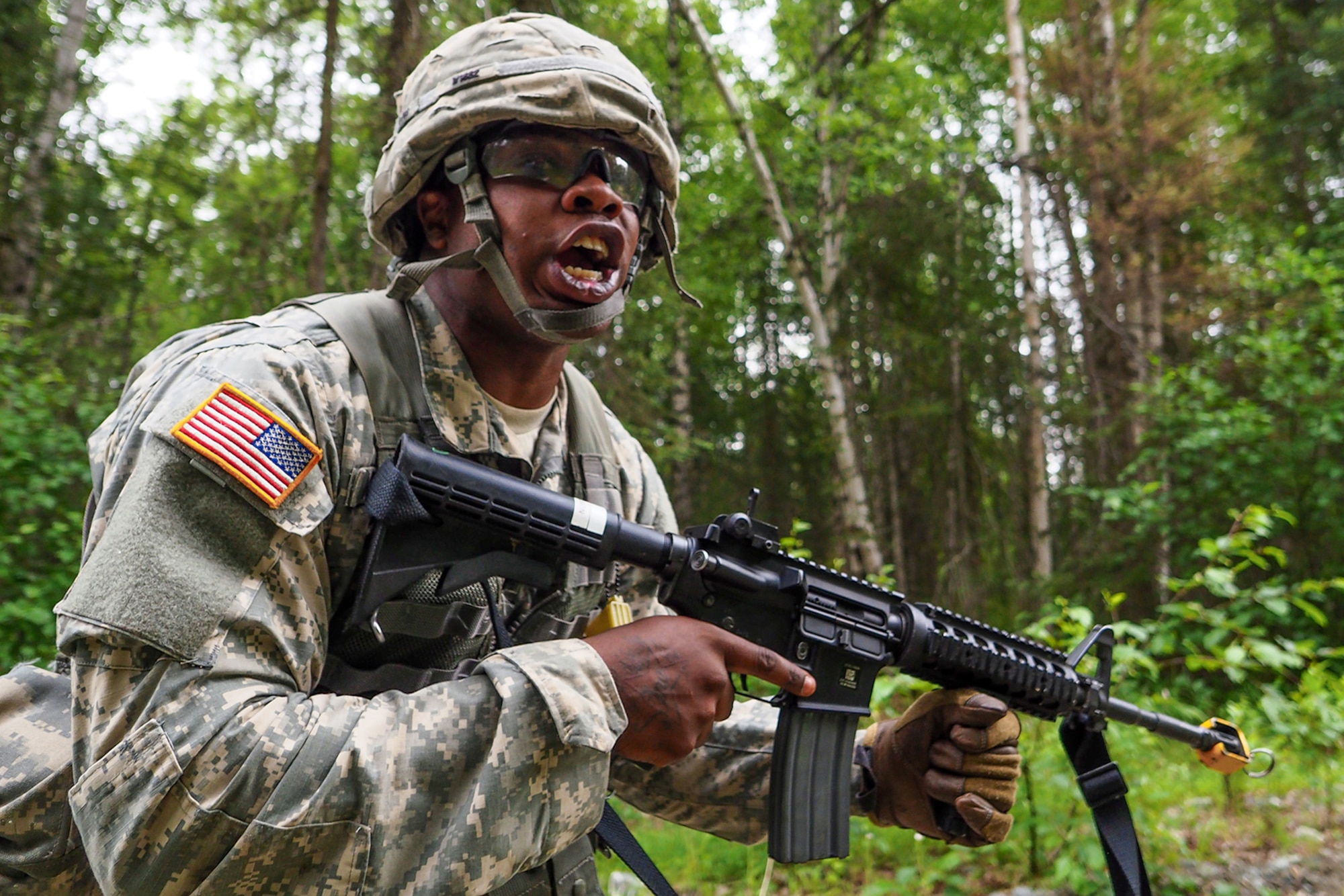 Spc. Gerald Wilson, a native of Dallas, Texas, assigned to the 486th Movement Control Team, 17th Combat Sustainment Support Battalion, U.S. Army Alaska, yells a warning about incoming indirect fire to his team as he throws himself to the ground on a Situation Exercise Training lane during the Ready Warrior Competition at Camp Madbull on Joint Base Elmendorf-Richardson, Alaska, Thursday, June 23, 2016.  The three-day competition tested teams of Soldiers in physical fitness, small arms proficiency, land navigation, and small-unit tactics as well as other Soldier skills. (U.S. Air Force photo/Justin Connaher)
