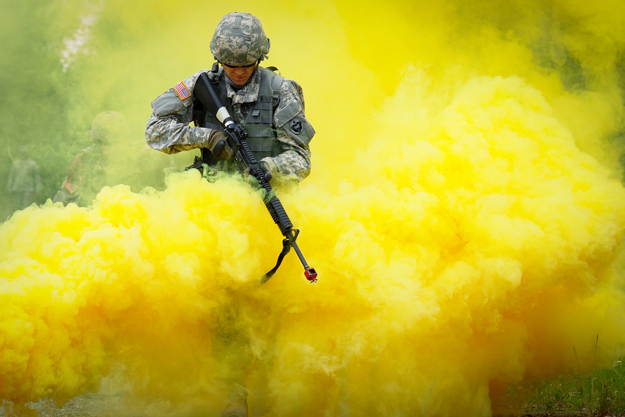 Army Pfc. Richard Burger, a native of Independence, Mo., assigned to the 574th Quartermaster Company, 17th Combat Sustainment Support Battalion, U.S. Army Alaska, runs through smoke marking a simulated casualty extraction point on a Situation Exercise Training lane during the Ready Warrior Competition at Camp Madbull on Joint Base Elmendorf-Richardson, Alaska, Thursday, June 23, 2016.  The three-day competition tested teams of Soldiers in physical fitness, small arms proficiency, land navigation, and small-unit tactics as well as other Soldier skills. (U.S. Air Force photo/Justin Connaher)