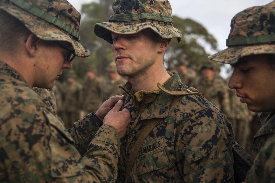 Marine Corps Cpl. Sean J. Whitley, a rifleman, gets a promotion to sergeant at Cultana Training Area in Australia, July 2, 2016. The promotion occurred at the beginning of Exercise Hamel, a training exercise with Australian, New Zealand and U.S. forces to enhance cooperation, trust and friendship. Whitley is assigned to 1st Battalion, 1st Marine Regiment, Marine Rotational Force Darwin. Marine Corps photo by Cpl. Carlos Cruz Jr.