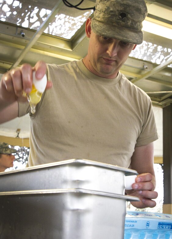Spc. Sean Dubois, a U.S. Army Reserve culinary specialist from Euclid, Ohio, with the 391st Military Police Battalion, cracks eggs to make orange-zest crepes while participating in the Philip A. Connelly Competition at Camp Atterbury, Indiana, June 23. The 391st is representing the 200th MP Command in the competition, part of a training program designed to improve professionalism and recognize excellence, which augments the quality of food and food service within the Army. The top four food service teams will continue to the U.S. Army Reserve level competition. (U.S. Army photo by Sgt. Audrey Hayes)