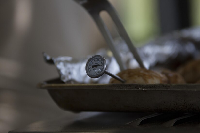 The temperature of savory chicken, a main staple of the 391st Military Police Battalion’s lunch menu, is checked during the Philip A. Connelly Competition at Camp Atterbury, Indiana, June 23. The 391st is representing the 200th MP Command in the competition, part of a training program designed to improve professionalism and recognize excellence, which augments the quality of food and food service within the Army. The top four food service teams will continue to the U.S. Army Reserve level competition. (U.S. Army photo by Sgt. Audrey Hayes)