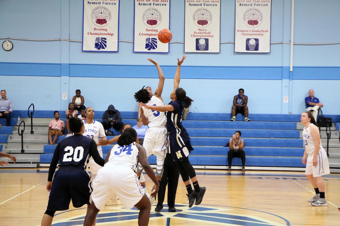 Navy Seaman Jameika Hoskins (#23) of the USS Rushmore and Air Force Senior Airman Jessica St. Cyr (#5) of Robins AFB, Ga. start game 9 of the 2016 Armed Forces Women's Basketball Championship at Joint Base San Antonio-Lackland AFB, Texas on 4 July.  Navy dominated the game winning 78-56.