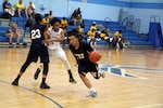 Navy Petty Officer 3rd Class Talena Faison (#20) of Yokosuka, Japan drives to the lane off a screen during game nine of the 2016 Armed Forces Women's Basketball Championship at Joint Base San Antonio-Lackland AFB, Texas on 4 July.  Navy dominated the game winning 78-56.