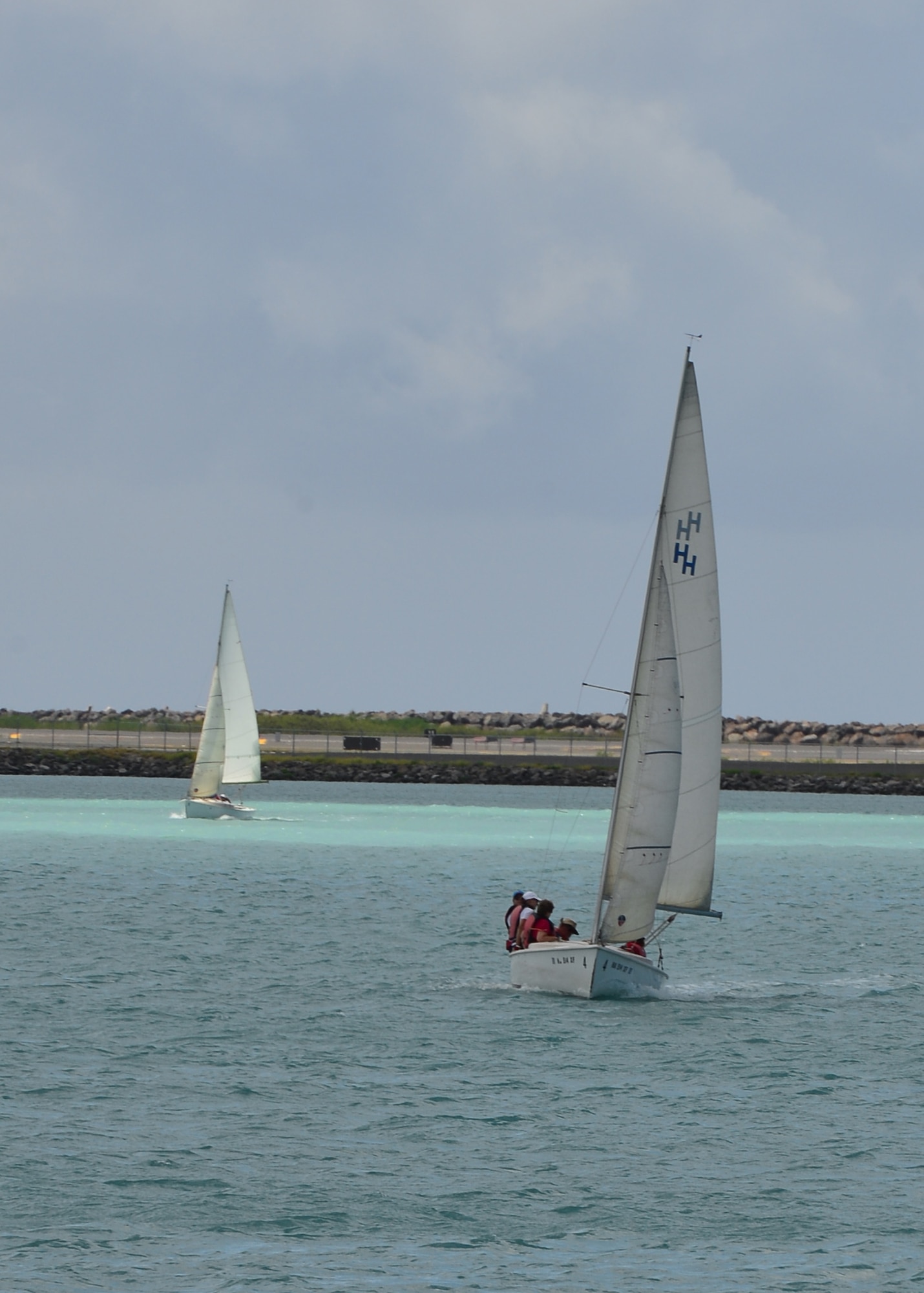 Members of the Wet Hens Sailing group sail around Hickam Harbor during the 55th anniversary reunion celebration on Joint Base Pearl Harbor-Hickam, June 30, 2016. In 1961, the group was founded by Air Force wives that learned to sail from then harbormaster, Lou Foster. Early in their training, he referred to his students as a bunch of "wet hens," and the name stuck. After learning to sail, the women wanted to share their newfound skills with other women. So those first "Wet Hens" started a tradition that has lasted 55 years. (U.S. Air Force photo by Teach. Sgt. Aaron Oelrich/Realeased) 
