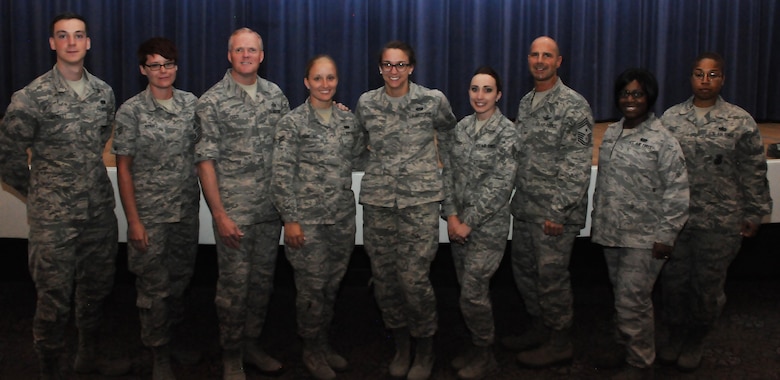 James A. Cody, Chief Master Sergeant of the Air Force, (third from left) and Chief Master Sergeant John F. Bentivegna, 50th Space Wing command Chief Master Sergeant, (third from right) gather for a photo with Schriever Airmen during an all-call at the Peterson Air Force Base, Colorado, Wednesday, June 29, 2016. The call was open to all enlisted Airmen in the Front Range. (U.S. Air Force photo/Airman William Tracy)