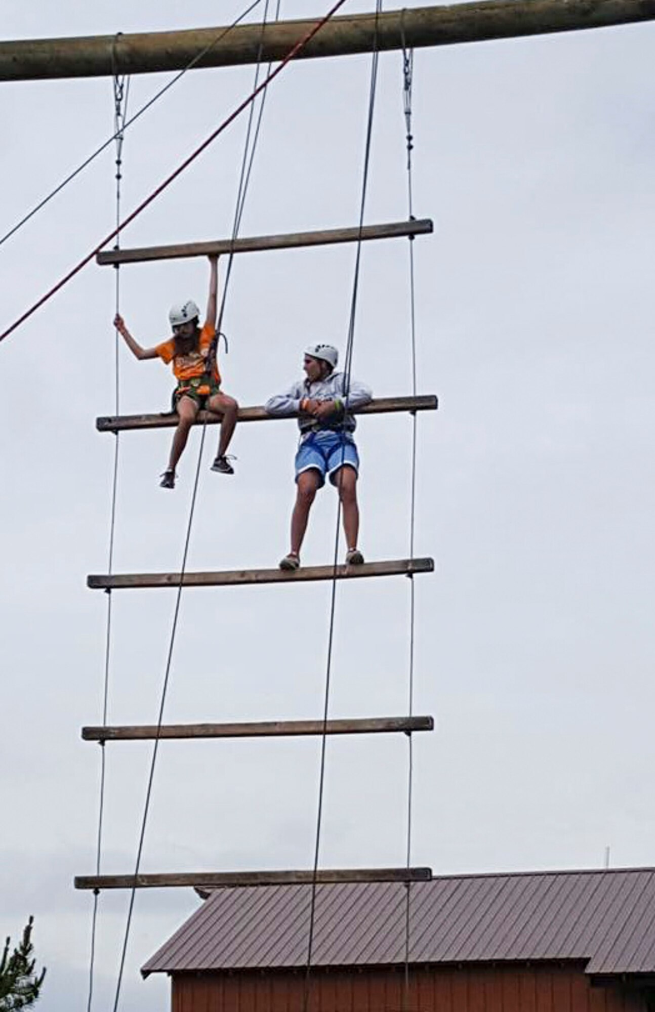 Two members of the Youth Leadership Camp, sponsored by Air Force Services Agency Child and Youth Programs and hosted by Buckley Air Force Base, climb an obstacle during a challenge June 27 – July 1 at the Snow Mountain Ranch in Granby, Colo. Youth from around the world came together to learn leadership techniques and build confidence for their future years of high school and beyond. (U.S. Air Force photo by Tech. Sgt. Nicholas Rau)