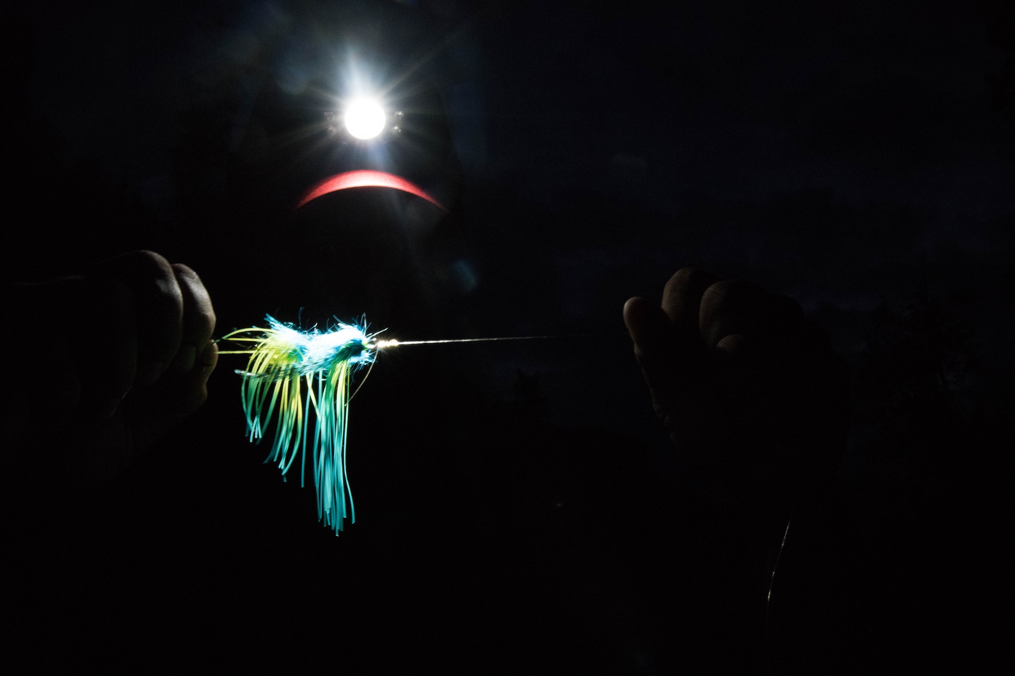 Josh Messerschmidt, spouse of Air Force Staff Sgt. Ruth Messerschmidt, examines his gear on the Russian River, Alaska, June 29. The area around Joint Base Elmendorf-Richardson has some of the most unique fishing opportunities in the world. To find out more information on fishing gear, contact Outdoor Recreation at 552-2023. (U.S. Air Force photo by Senior Airman Kyle Johnson)