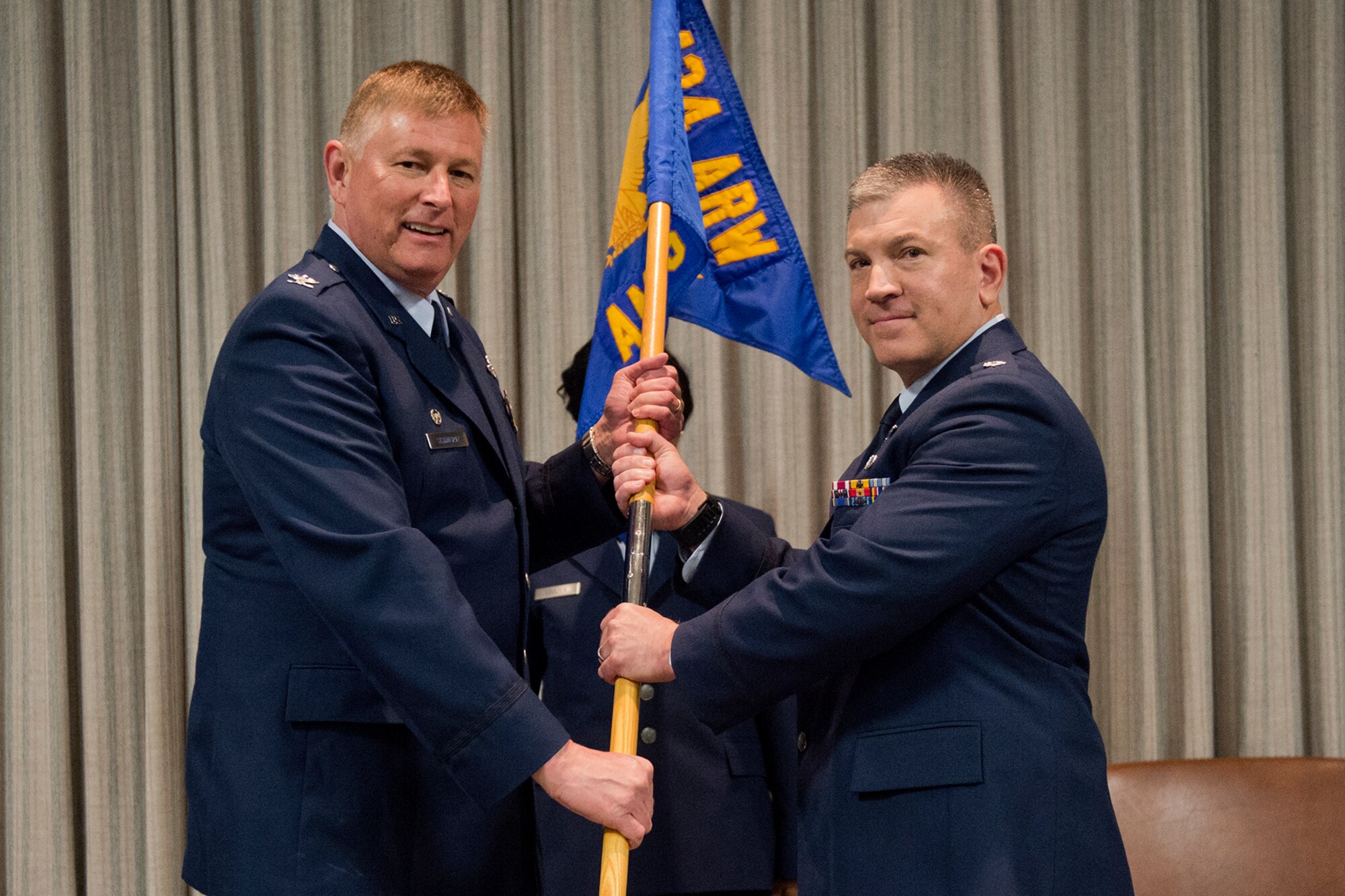 Lt. Col. Peter Weber, 434th Aerospace Medicine Squadron commander, receives the 434th AMDS guidon from Col. Doug Schwartz, 434th Air Refueling Wing commander, during a change of command ceremony at Grissom Air Reserve Base, Ind., May 15, 2016. Weber has served alongside the men and women of the 434th ARW for eight years and continues to serve as a senior leader. (U.S. Air Force photo/Staff Sgt. Jami Lancette)