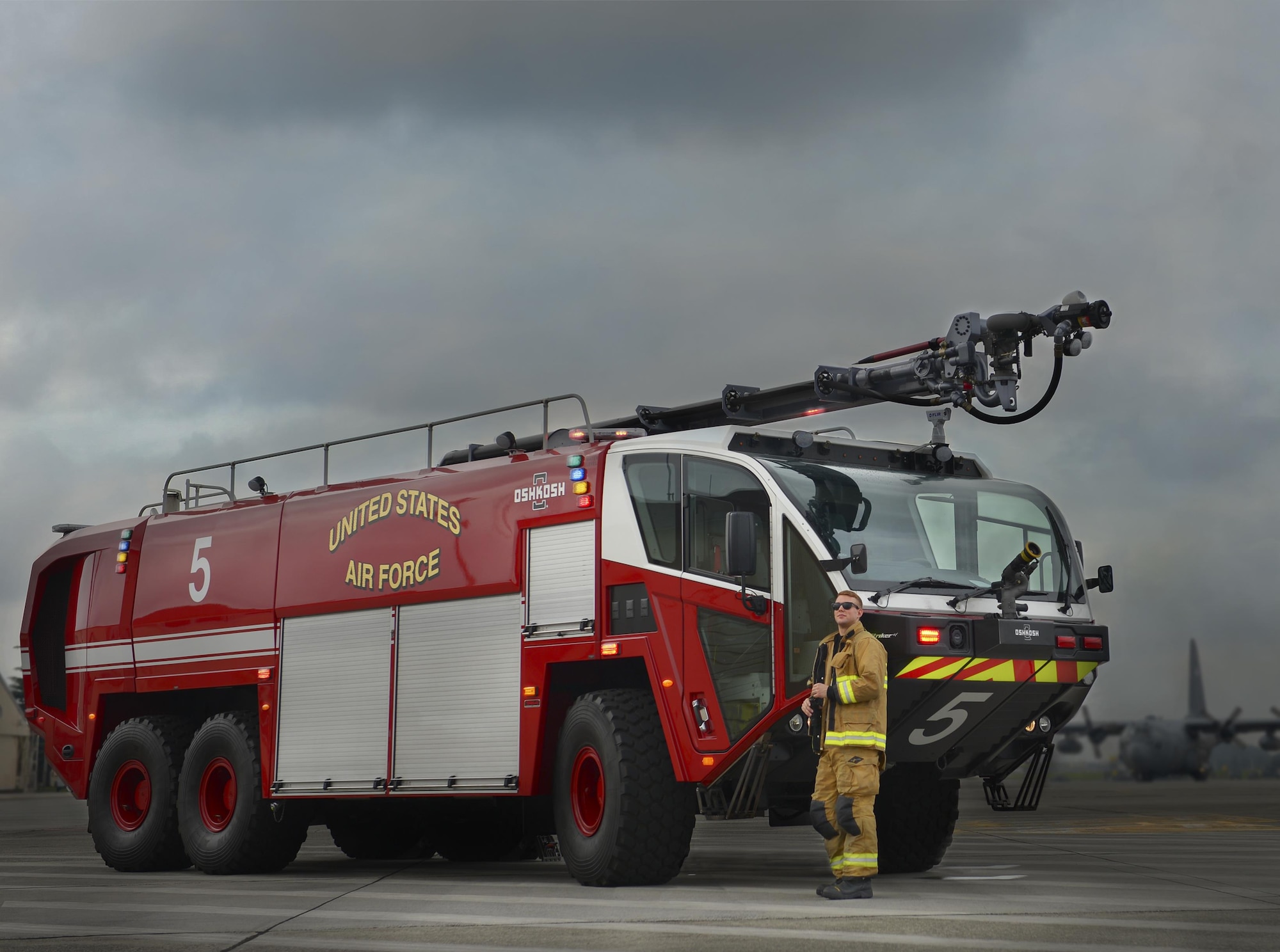 Airman 1st Class Thomas Smith, 374th Civil Engineer Squadron firetruck driver operator, poses for a photo with a Striker 3,000 fire truck at Yokota Air Base, Japan, June 28, 2016. The Striker 3,000 is Yokota’s newest fire truck and is specialized with features like the hull-piercing snozzle to combat aircraft-related fires. (U.S. Air Force illustration by Airman 1st Class Baker/Released)